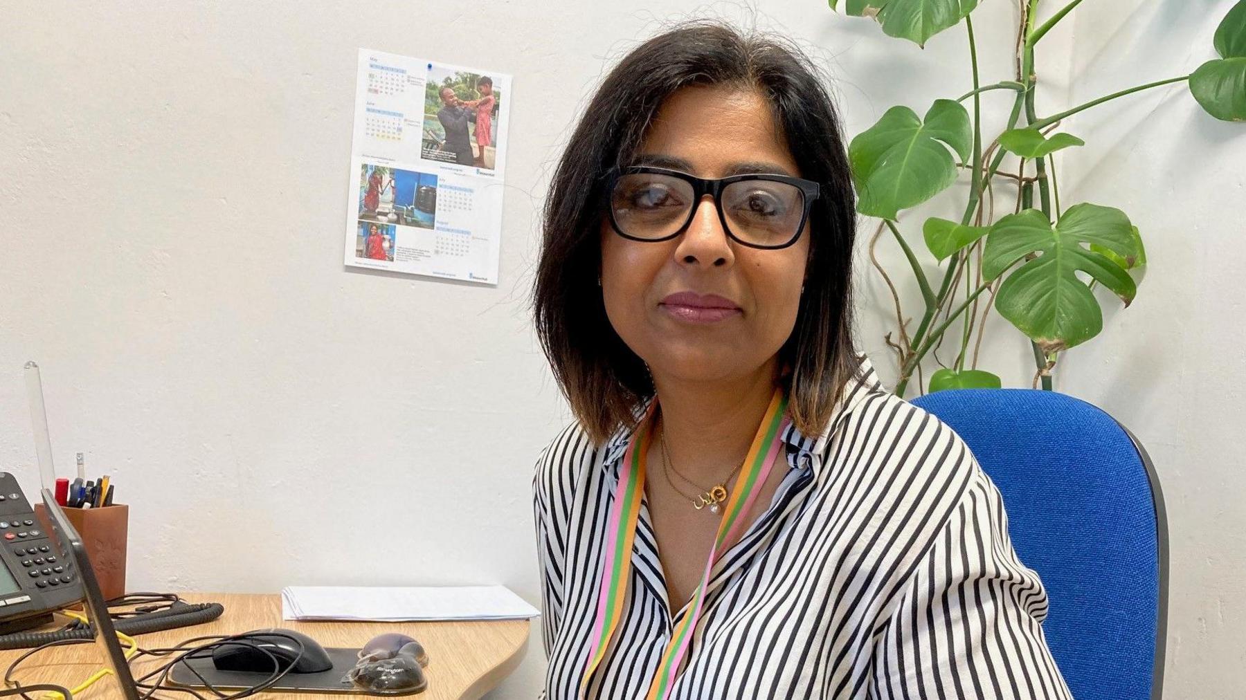 Bradford Council's assistant director for neighbourhoods and communities Noreen Akhtar sitting at a desk