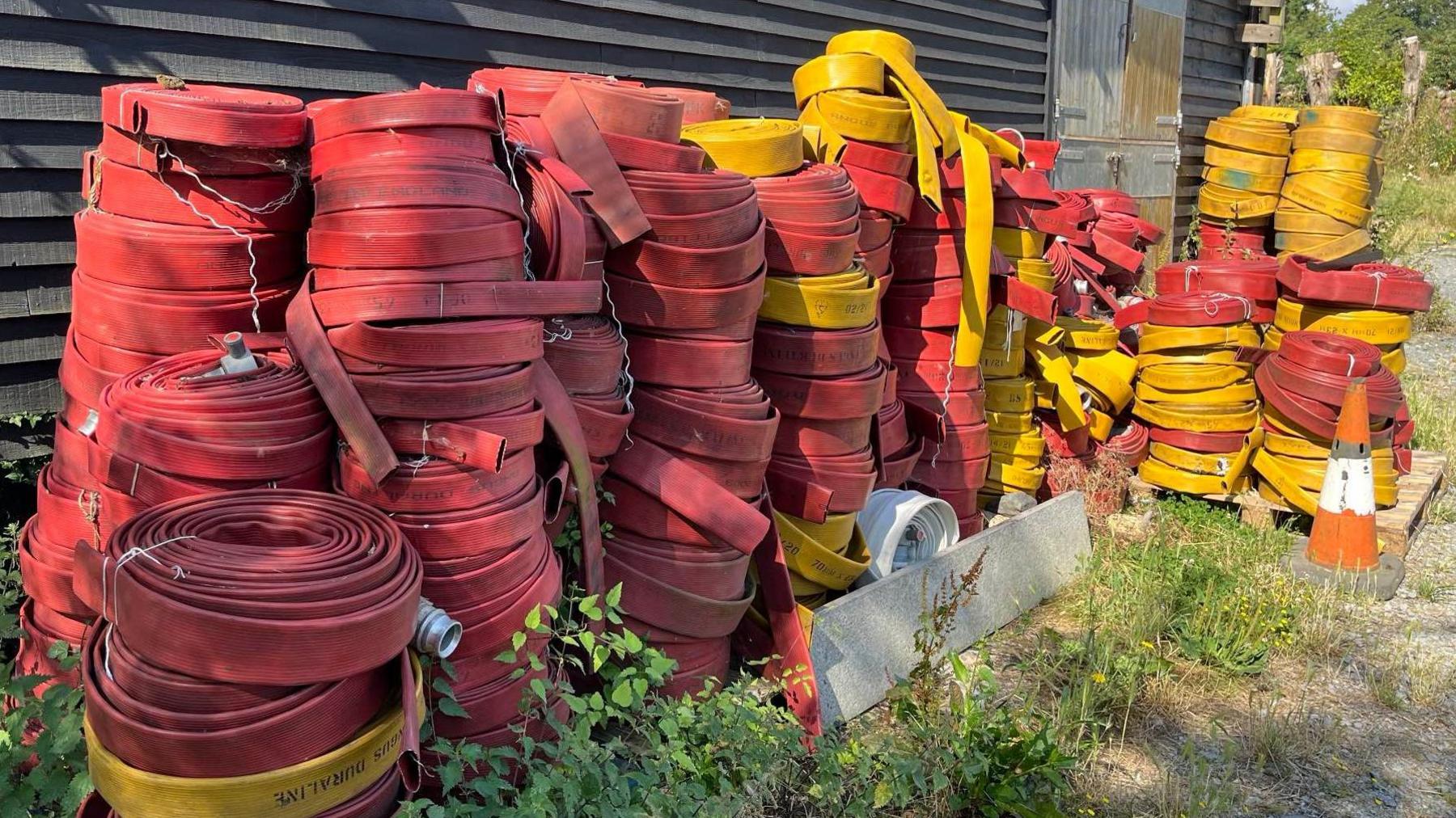 Redundant firehoses stored outside barn at Elvis & Kresse