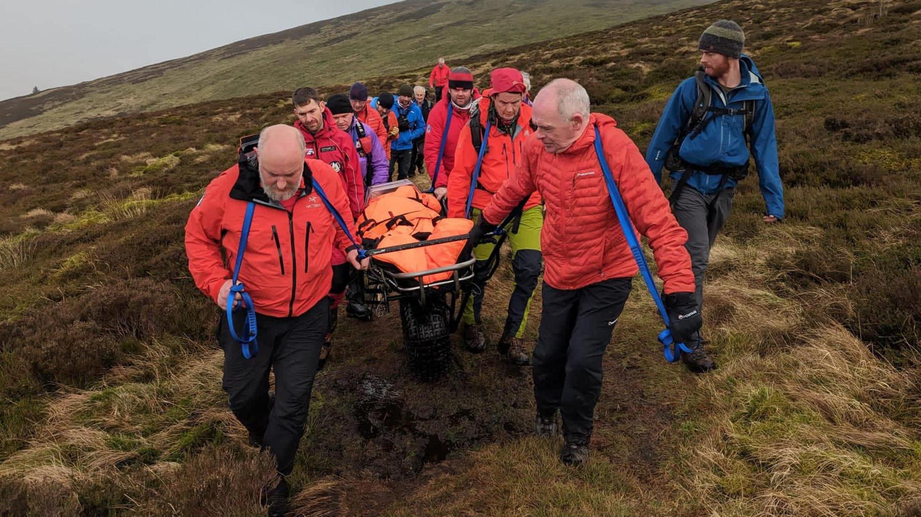 Mountain rescuers evacuating the casualty