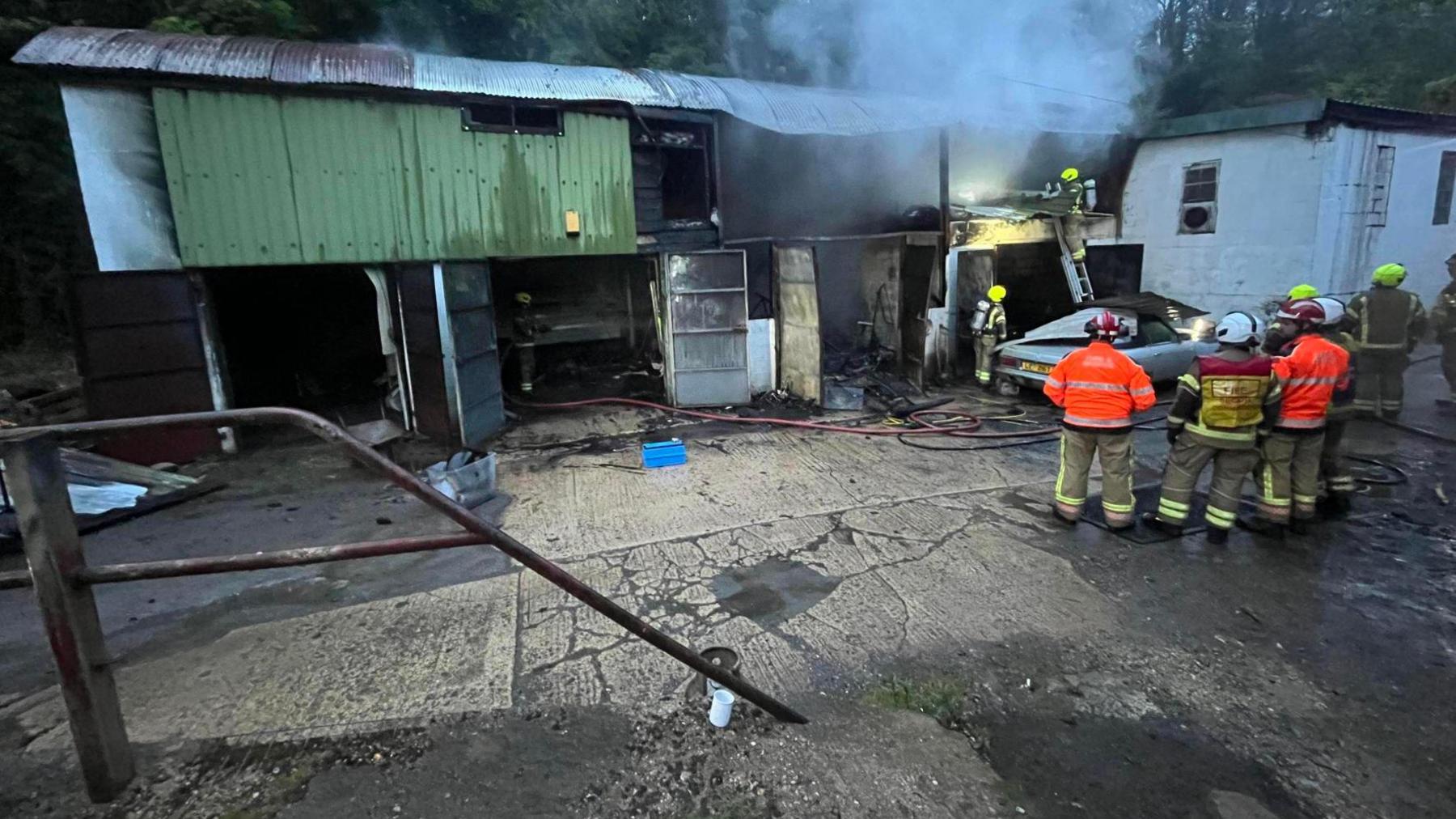 Firefighters and smoke outside an industrial unit