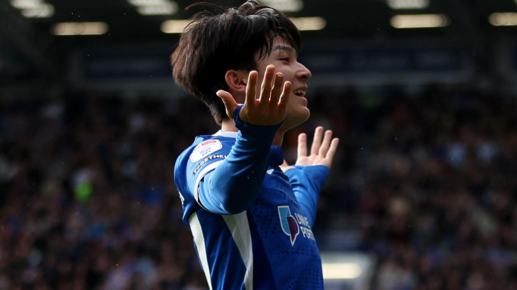Portsmouth's South Korean Yang Min-hyeok takes the acclaim of the crowd with a smile and his arms aloft