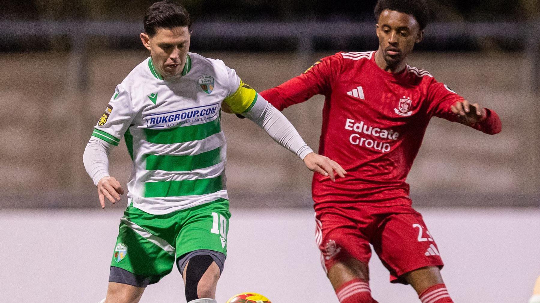 New Saints' Danny Redmond (left) battles for the ball with Abdi Sharif of Connah's Quay