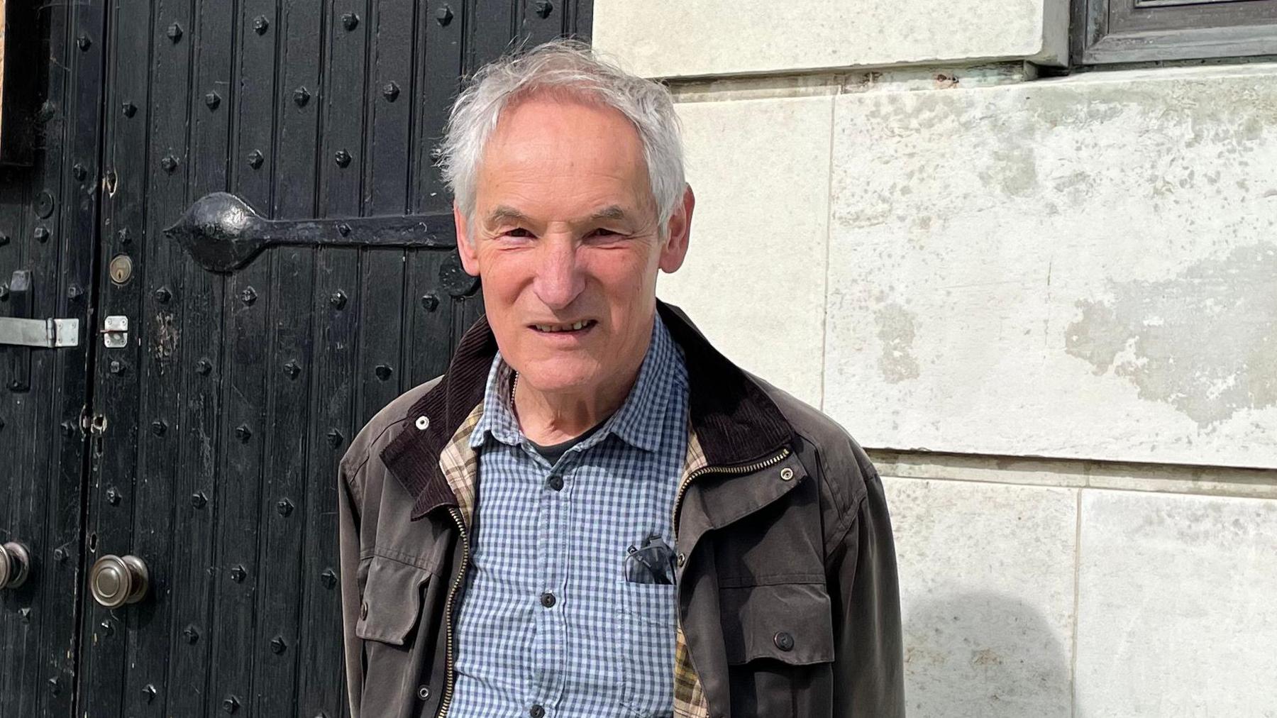 Steve Coltman stood in front of door of museum