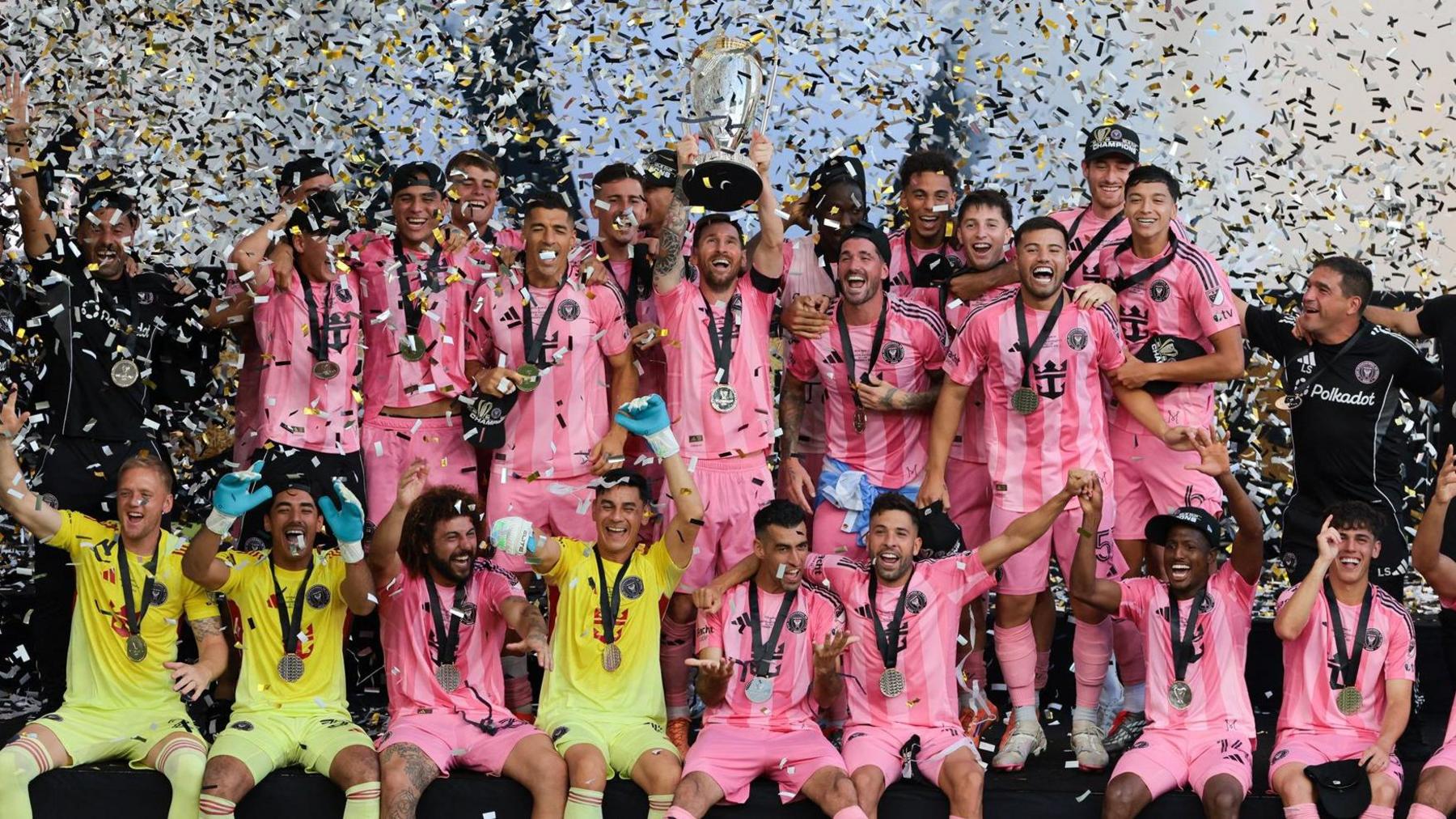 Lionel Messi holds up the MLS Cup as Inter Miami team-mates celebrate