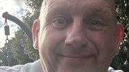 A family phot of Simon Clayton, taken in close-up, showing him smiling directly into the camera