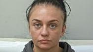 Police custody shot of Danielle Houghton with dark brown hair in a high ponytail wearing a dark brown hoodie. 