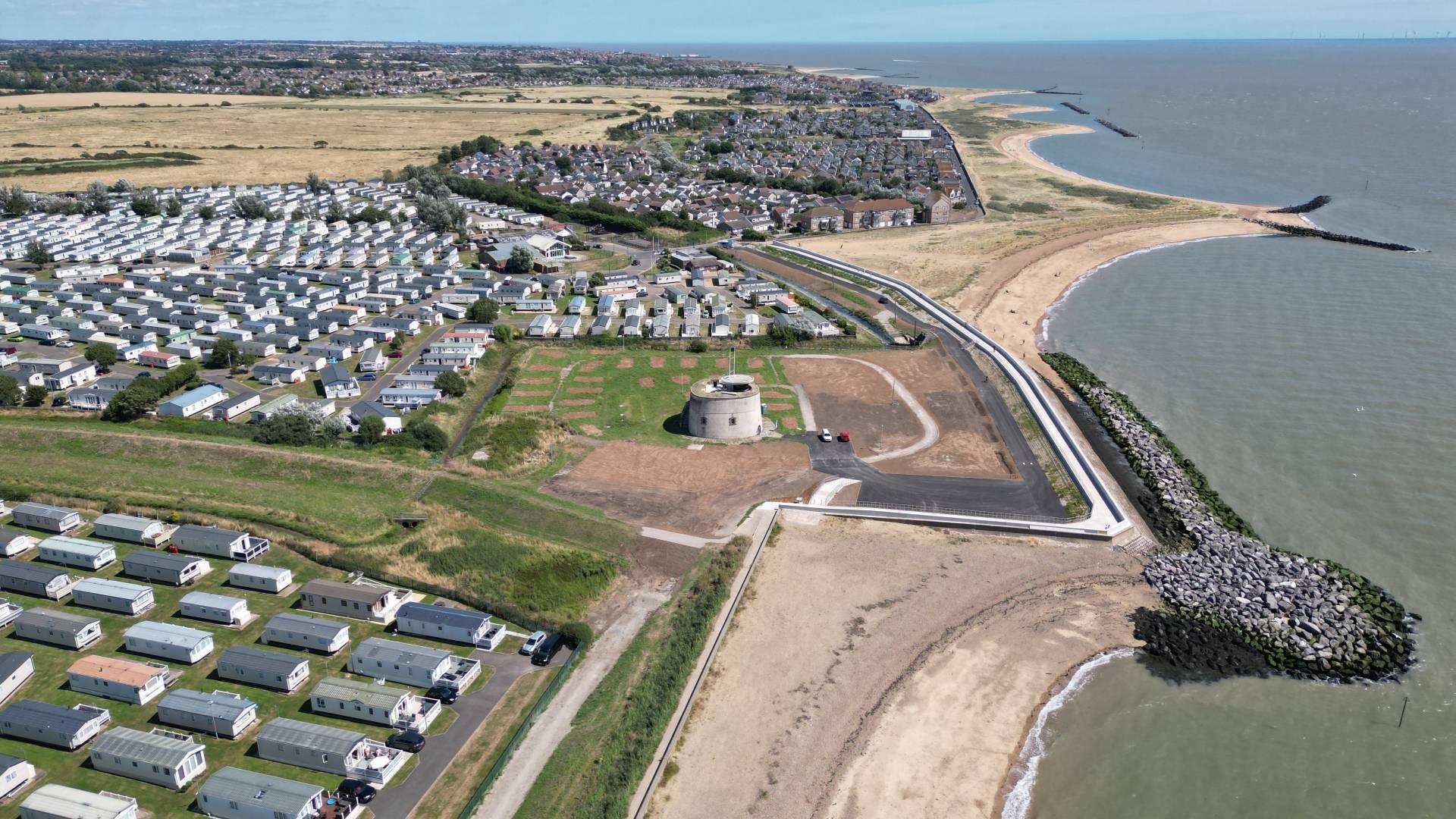 Image of sea and homes and businesses on the coastline