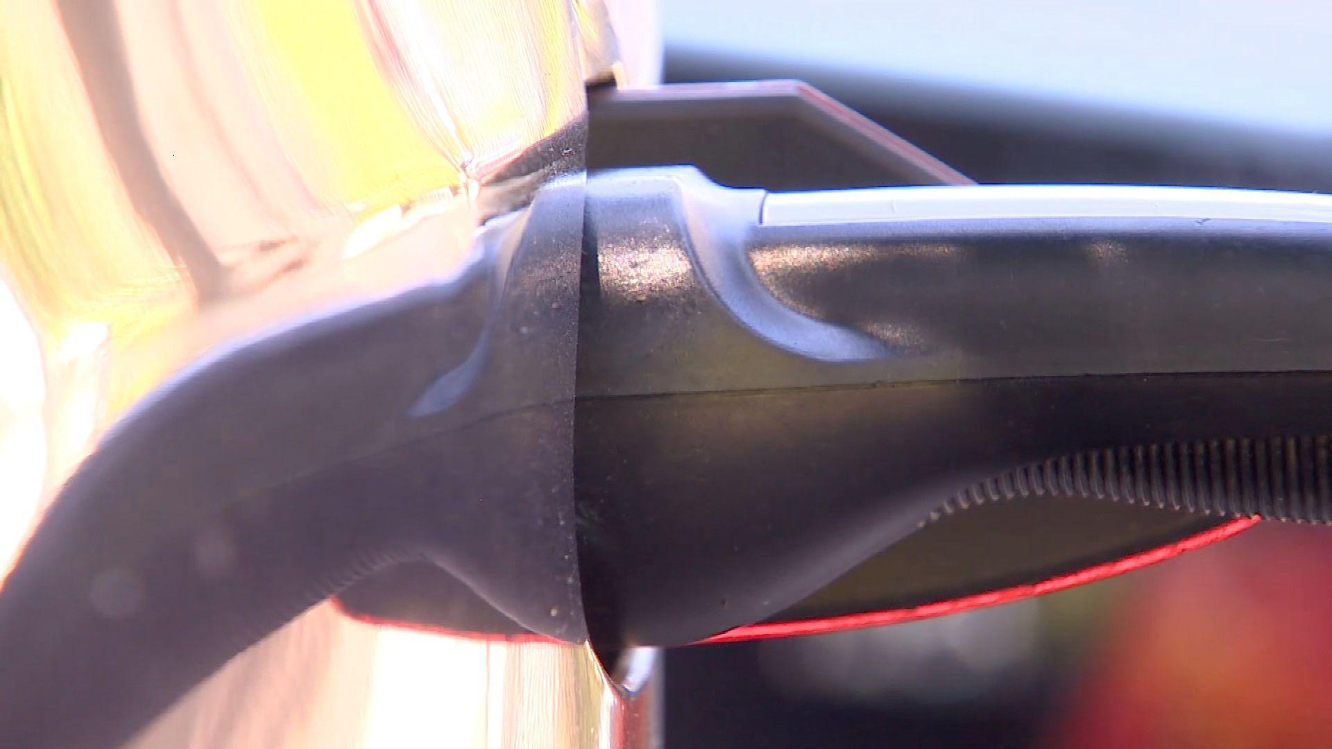 A power cable is connected to an electric car as it is charging