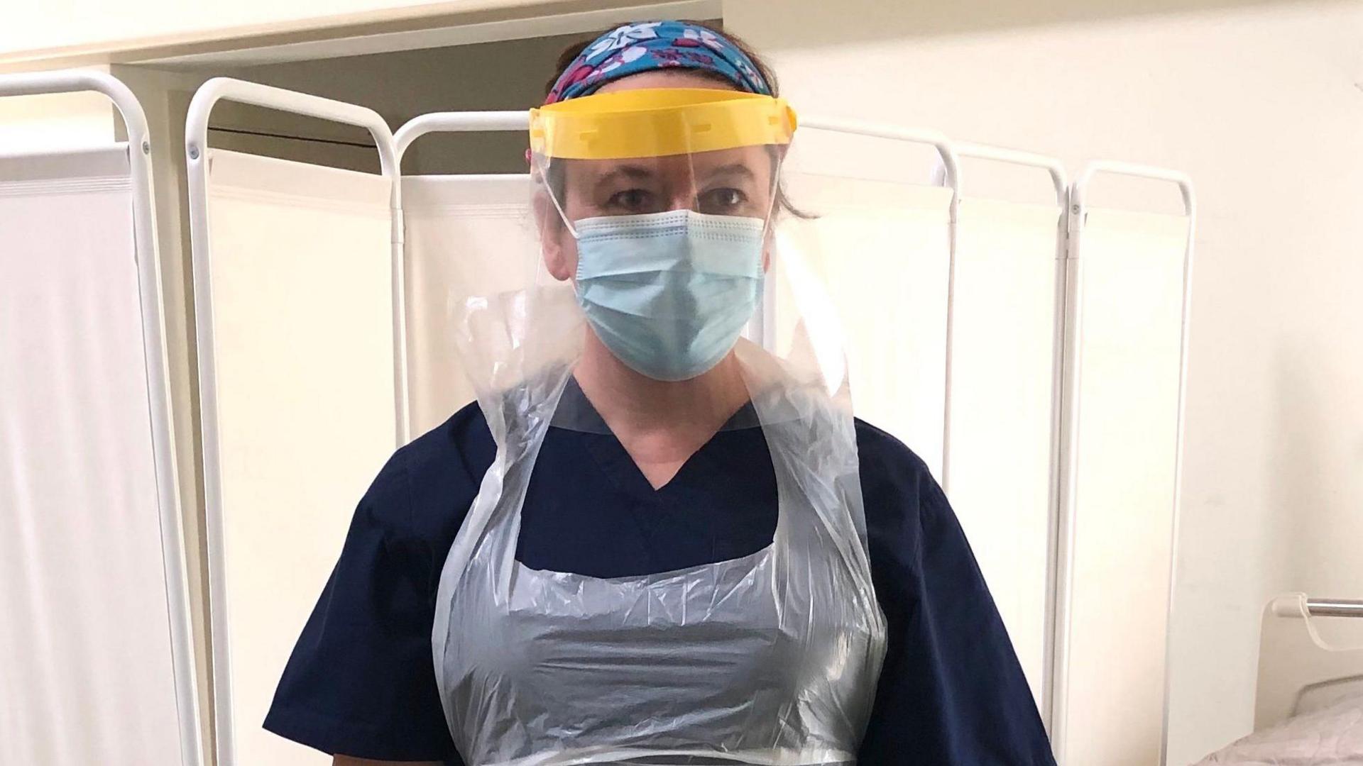 Dr Rachel Clarke dressed in scrubs, an apron and a protective mask as she worked on hospital wards throughout the covid pandemic