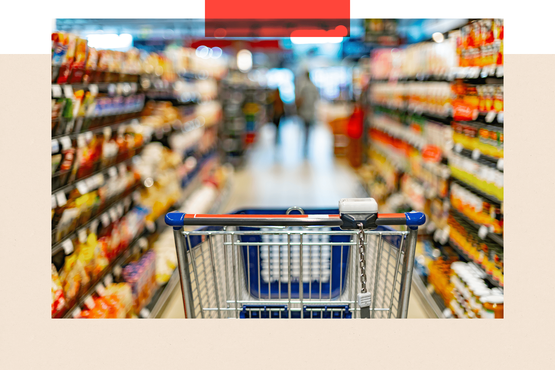 A shopping cart in the aisle of a supermarket