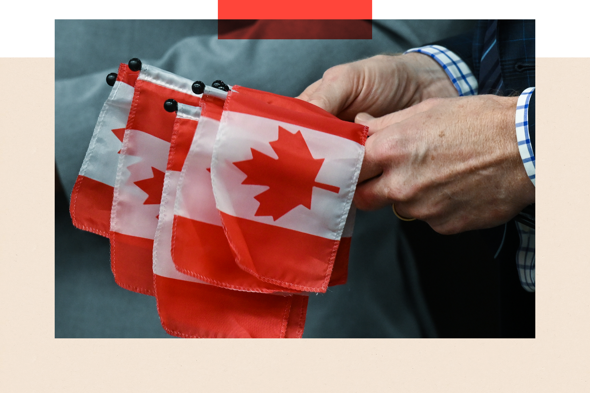 Small Canadian flags held in a hand