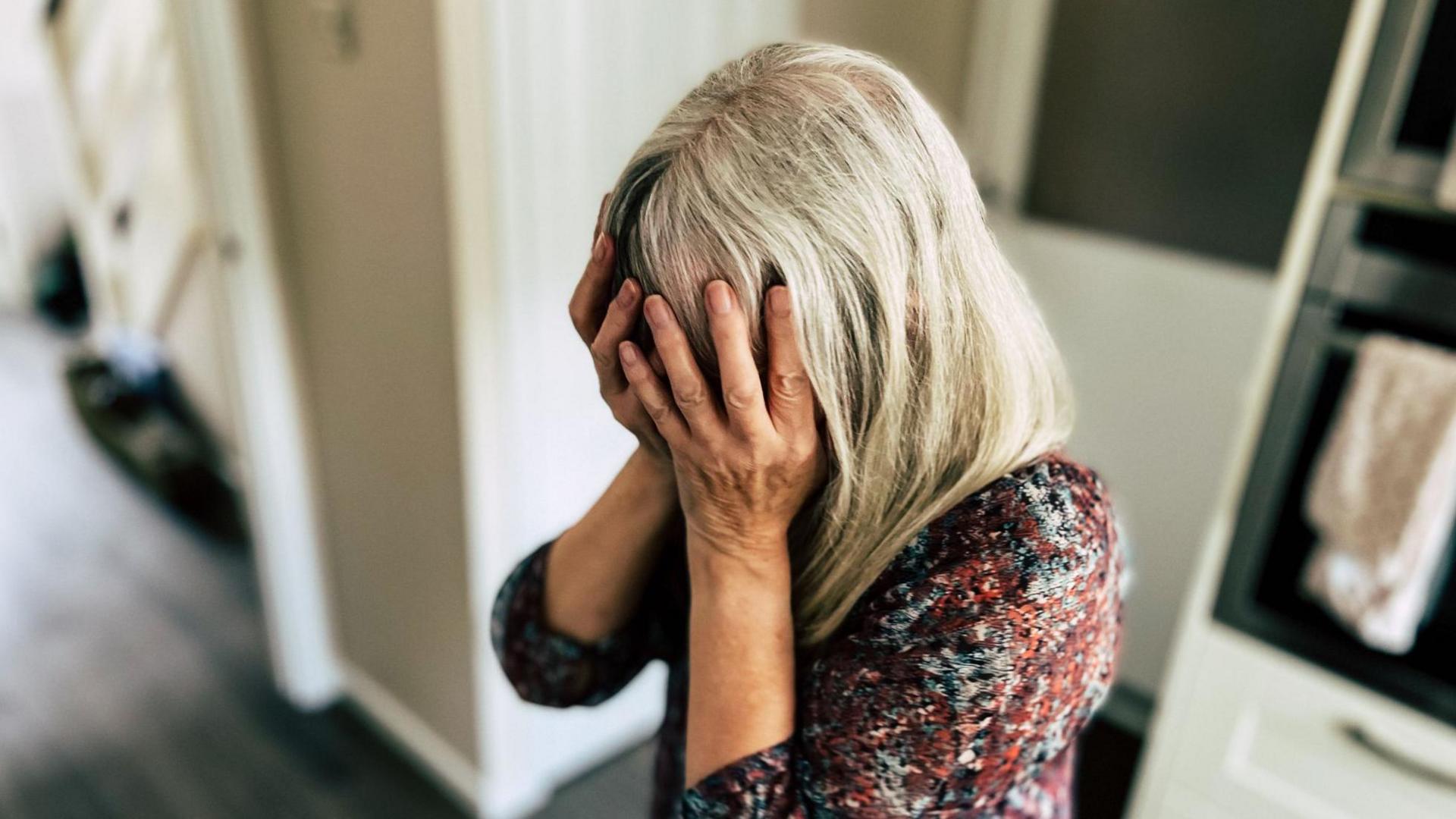 Woman with head in her hands