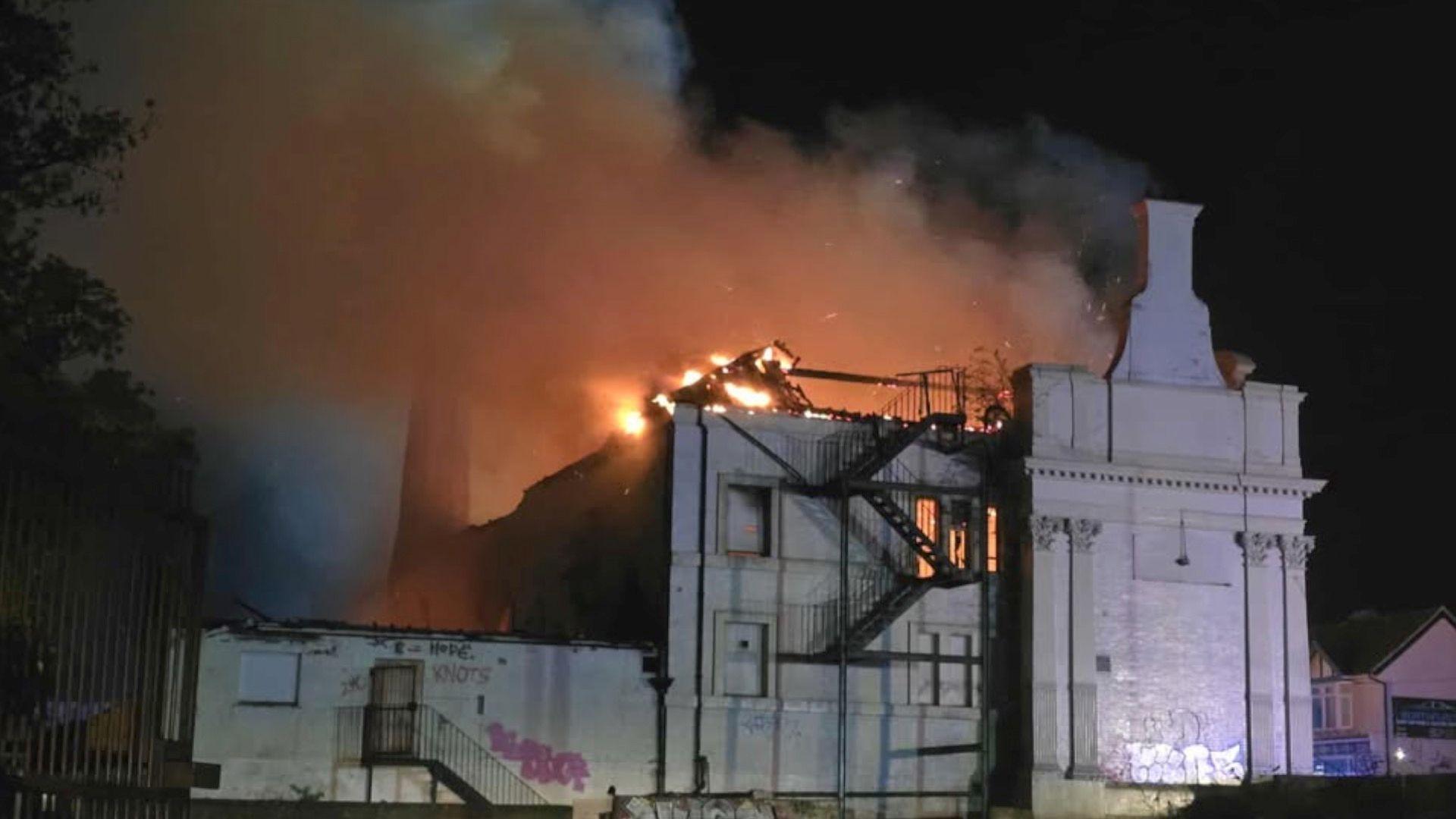 Building on fire with orange flames and smoke