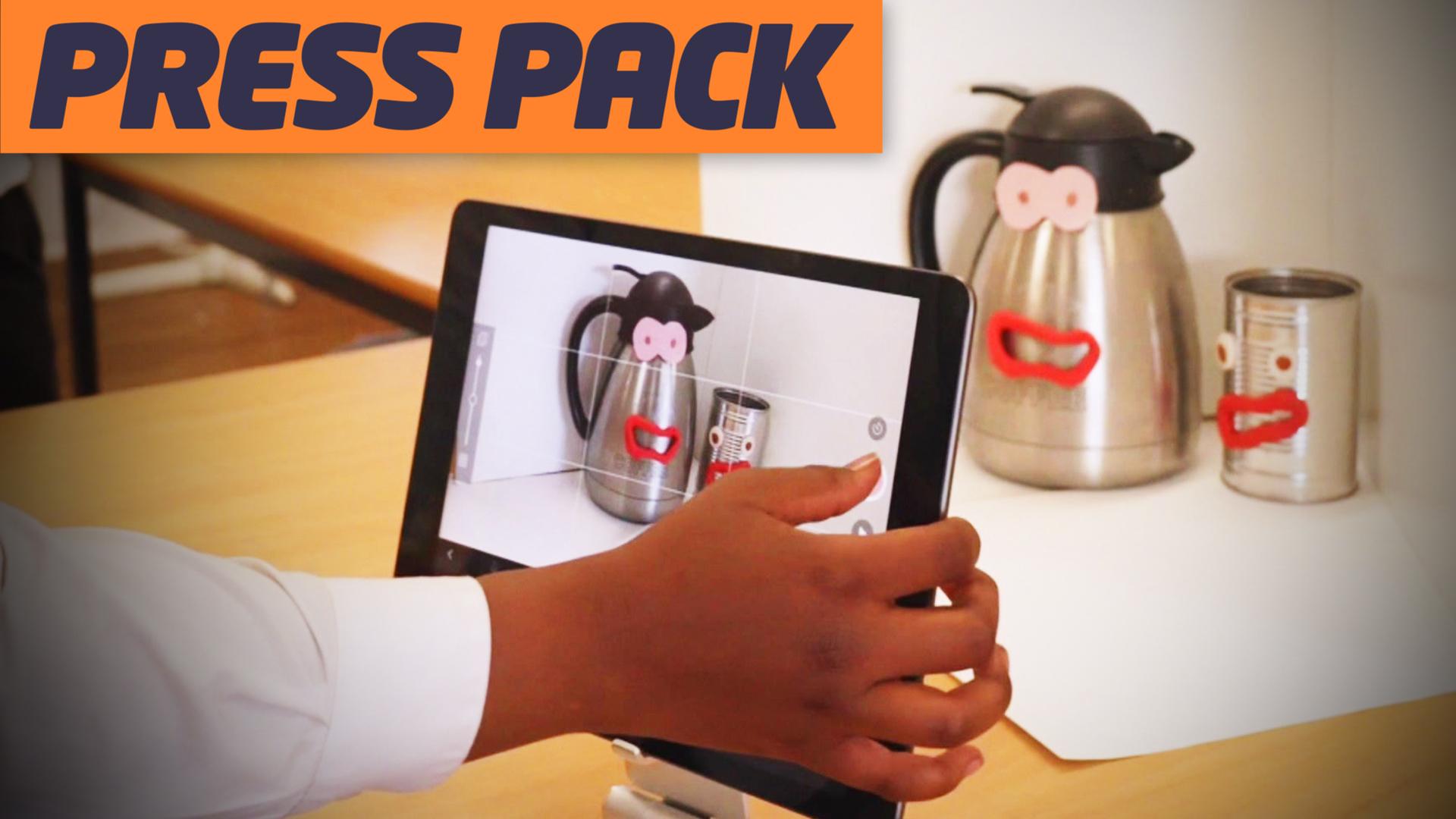 a hand hovers over a tablet taking a picture of a kettle and mug with smiley faces stuck on them - the logo press pack is in the top right hand corner