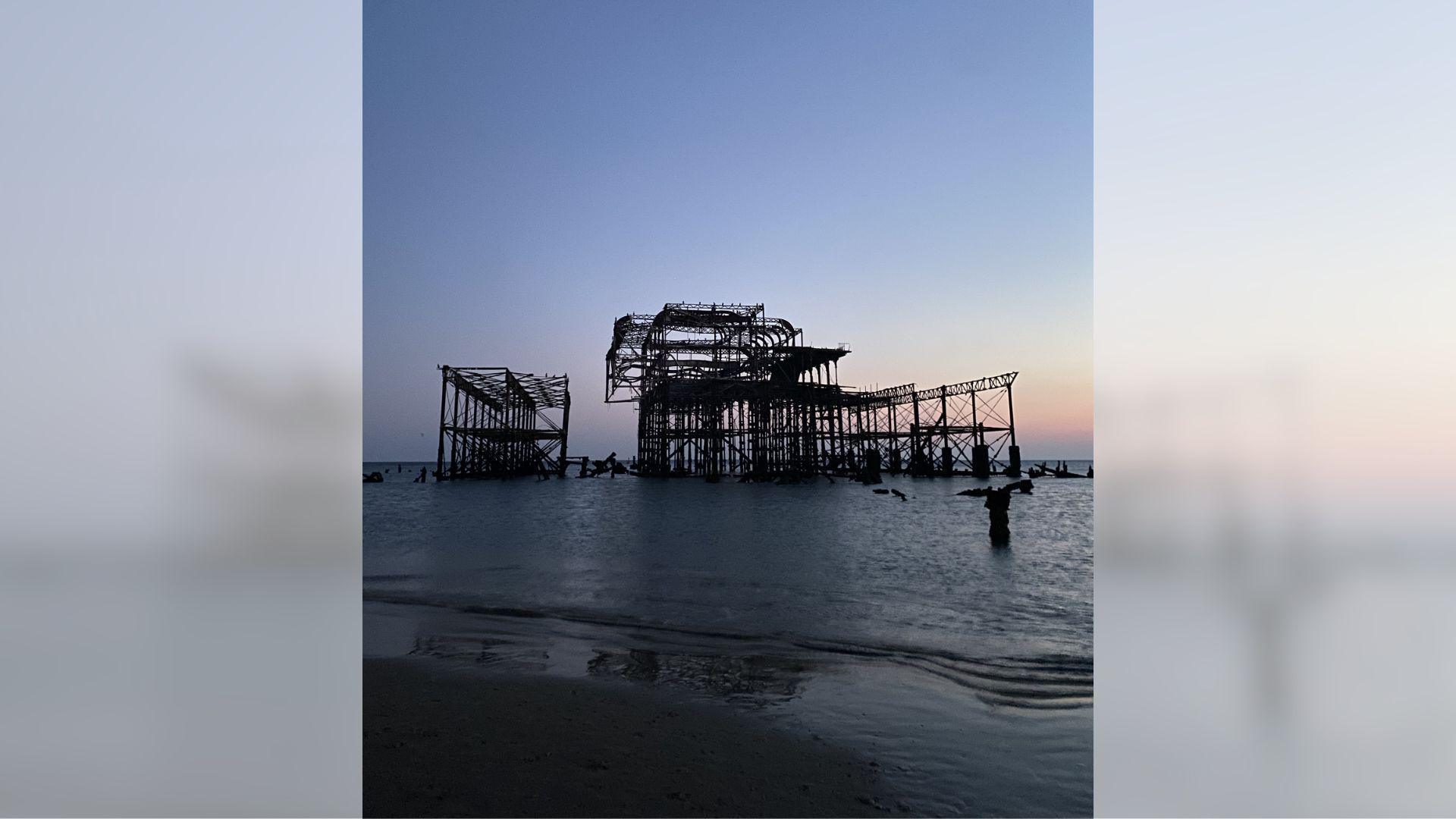 Brighton's West Pier from close-up during a low tide and sunset