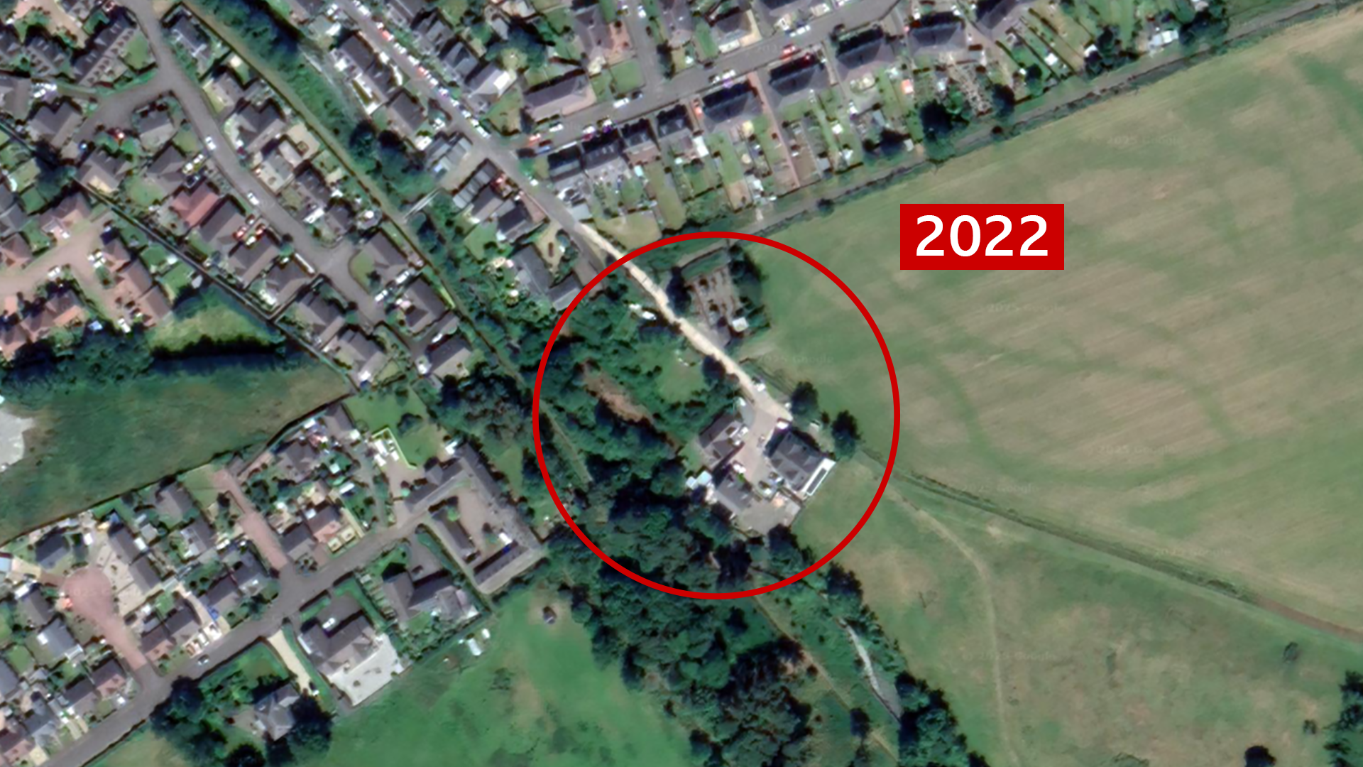 A satellite image of the site located in Innerleith near the Scottish Borders. The site is marked with a red circle in the centre and the year '2022' is also marked to the right, in red and white. It looks like a domestic area around the site and there is a lot more green shrubbery around the area, trees cover majority of the site. It's hard to say what would be underneath them. 