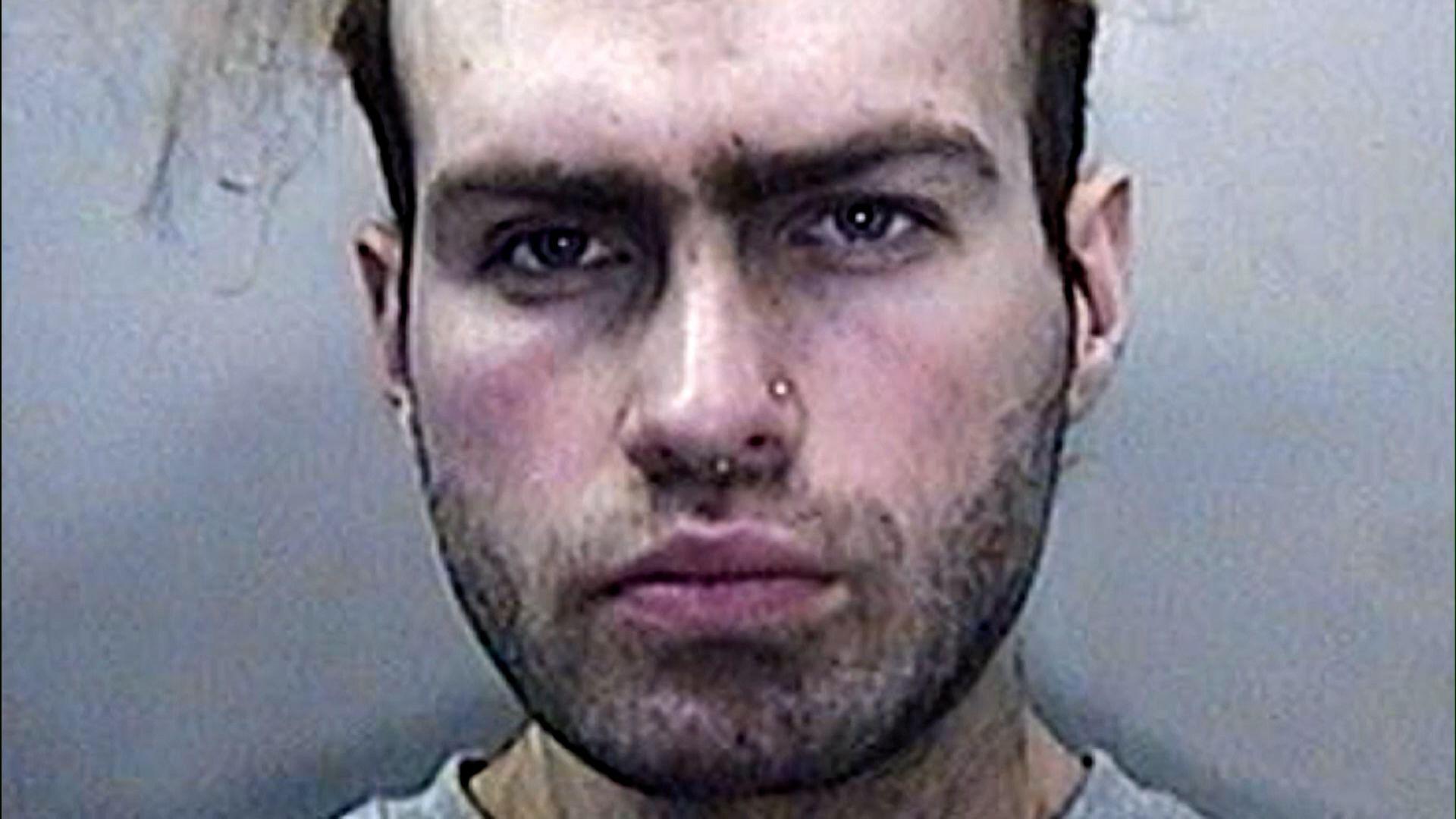 South Wales Police 'mugshot' of Luke Deeley after his arrest, looking unshaven with a nose ring and hair shaved at the sides