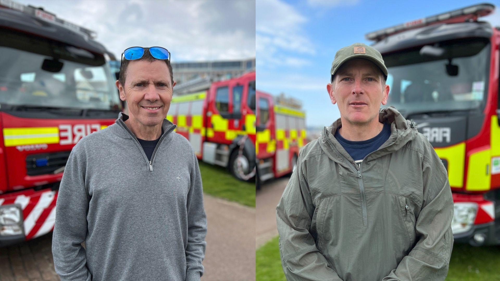 Both men look at the camera as they stand by the fire engines. In the photo of Paul he is wearing a grey jumper and has sunglasses on his forehead. Steven has a dull green coat on and a cap of a similar colour.