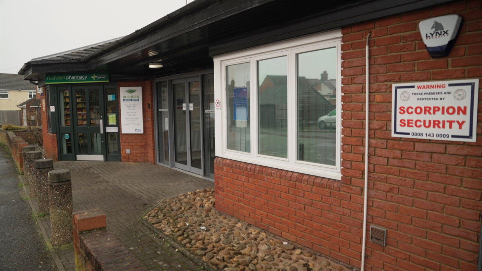 The front entrance of Rushden Medical Centre, a one-storey red brick building