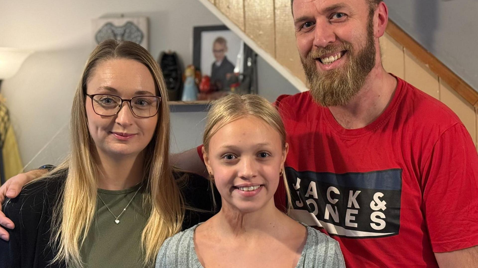 Rosie-May, centre, with mum Ellie (left) and dad James (right)