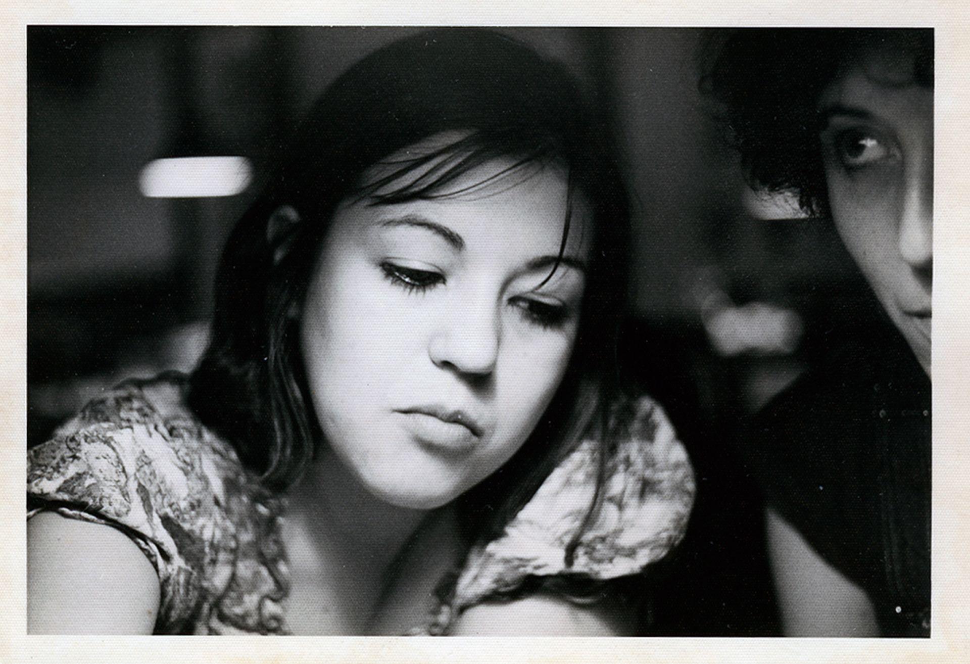 A black-and-white picture of a young Mariona, a girl with dark hair looking down