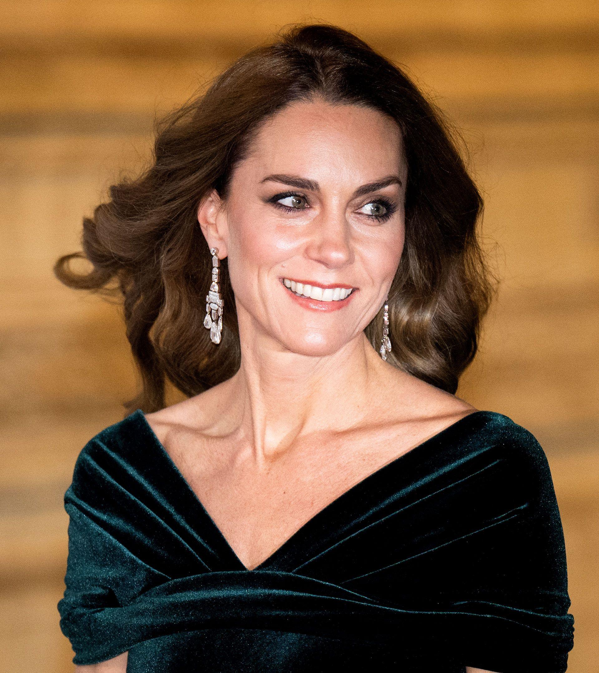 Princess Catherine of Wales smiles as she wears a green gown at the Royal Variety Performance