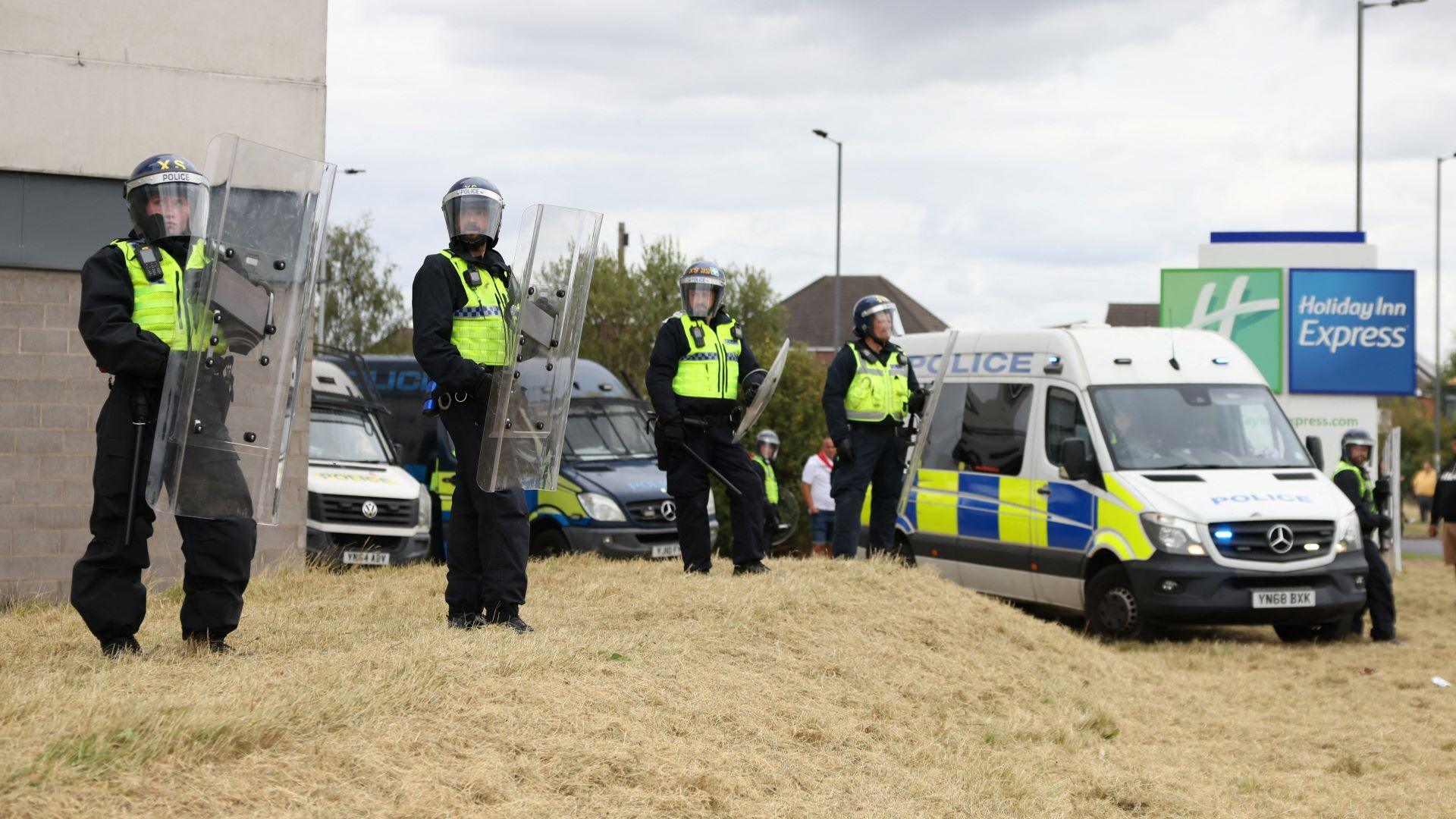 Police officers standing with riot shields