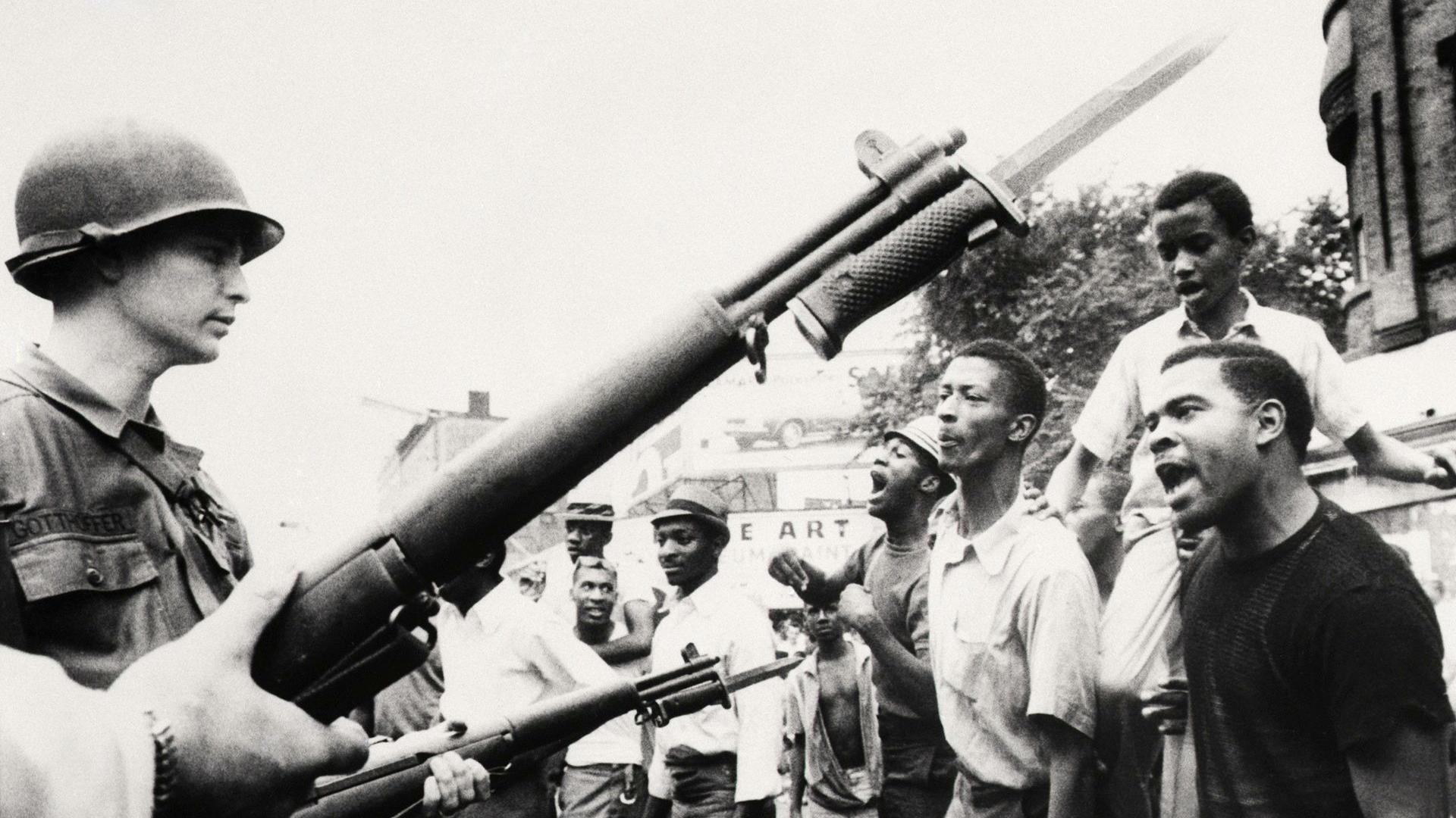 Y fyddin o flaen criw o ddynion