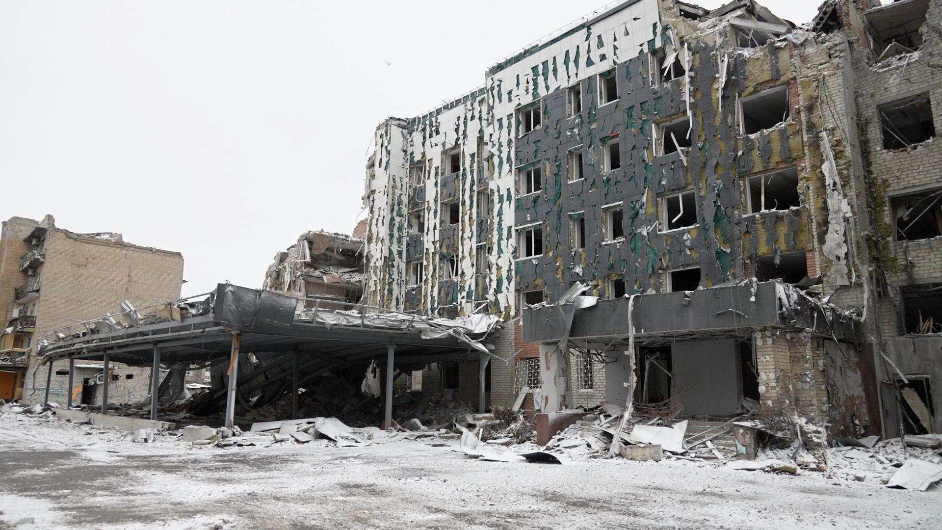 A dusting of snow is on the ground outside a ruined four-storey building in Pokrovsk in eastern Ukraine