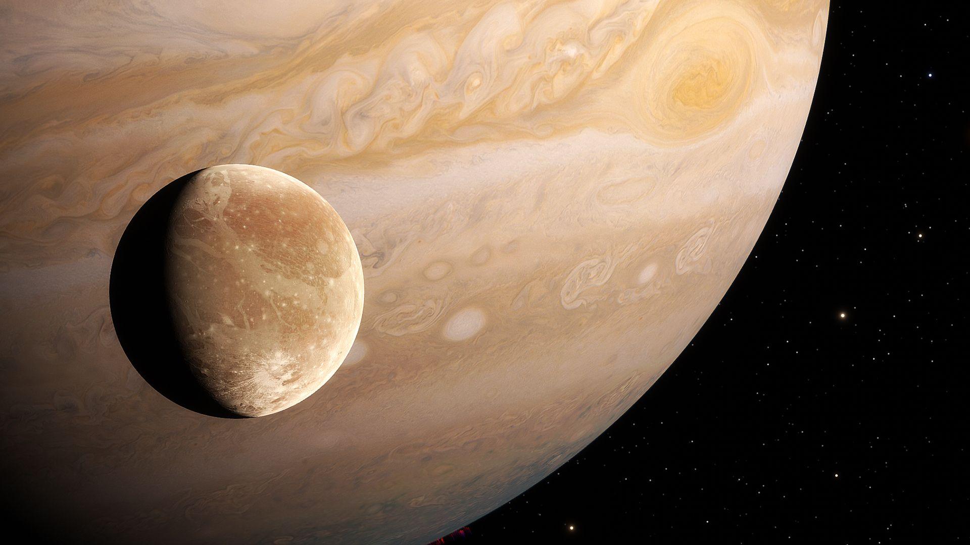 An artists' impression of Ganymede, an amber coloured moon that is in the foreground orbiting an extremely large planet called Jupiter