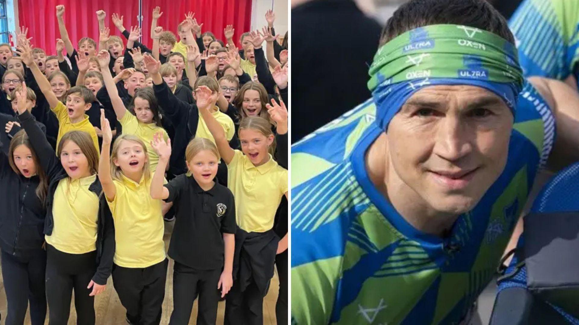 The image is split into two sections. On the left, a large group of schoolchildren wearing yellow and black uniforms stand indoors in front of a bright red curtain, raising their hands enthusiastically. On the right, a close-up of Kevin Sinfield wearing a blue and green patterned athletic shirt and a green headband.