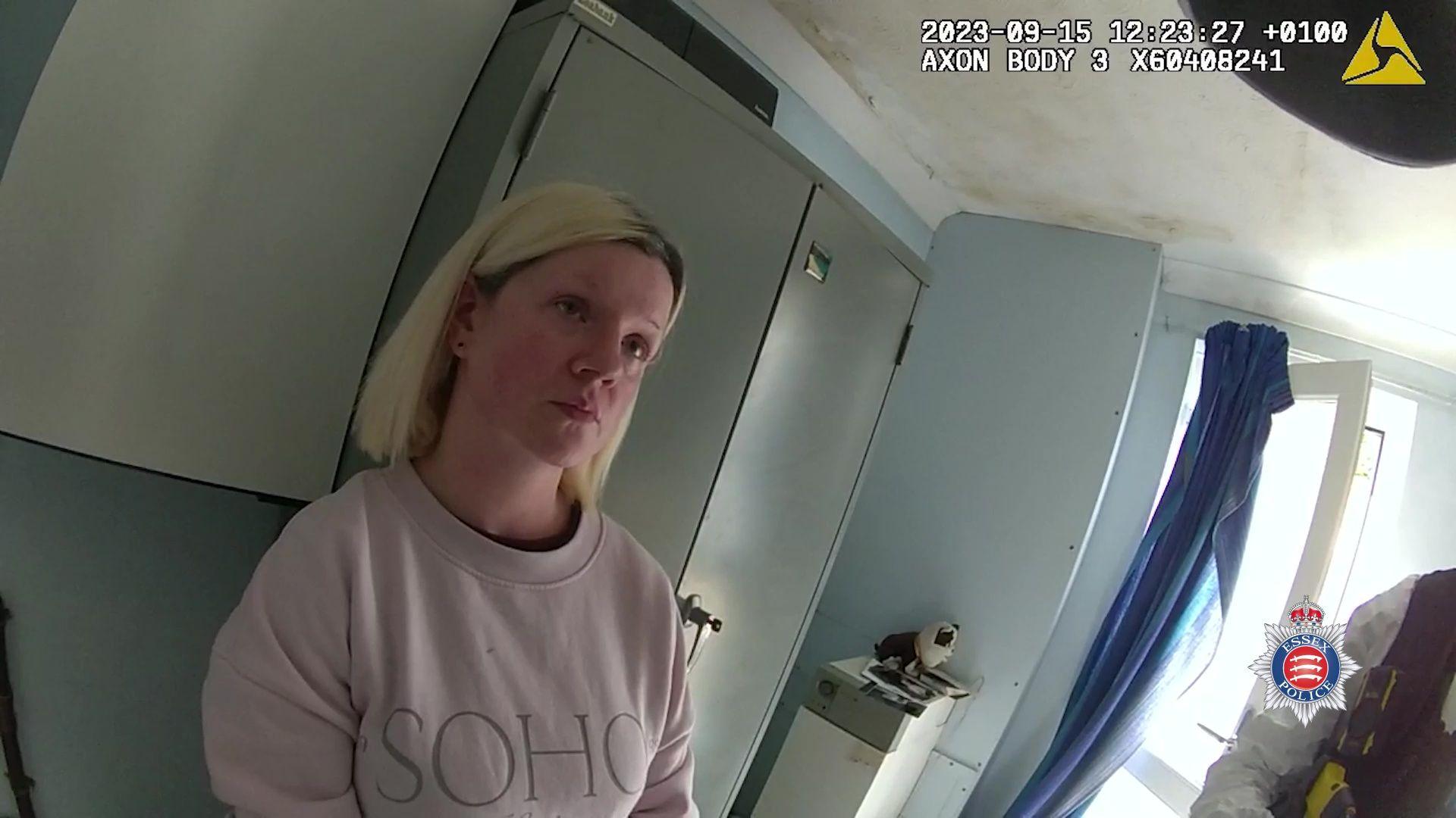 A screen grab taken from bodyworn video dated 15 September 2023 issued by Essex Police of the arrest of Victoria McCullough at her home in Pump Hill, Chelmsford. McCullogh is wearing a pink jumper and is leaning against a cupboard looking forwards