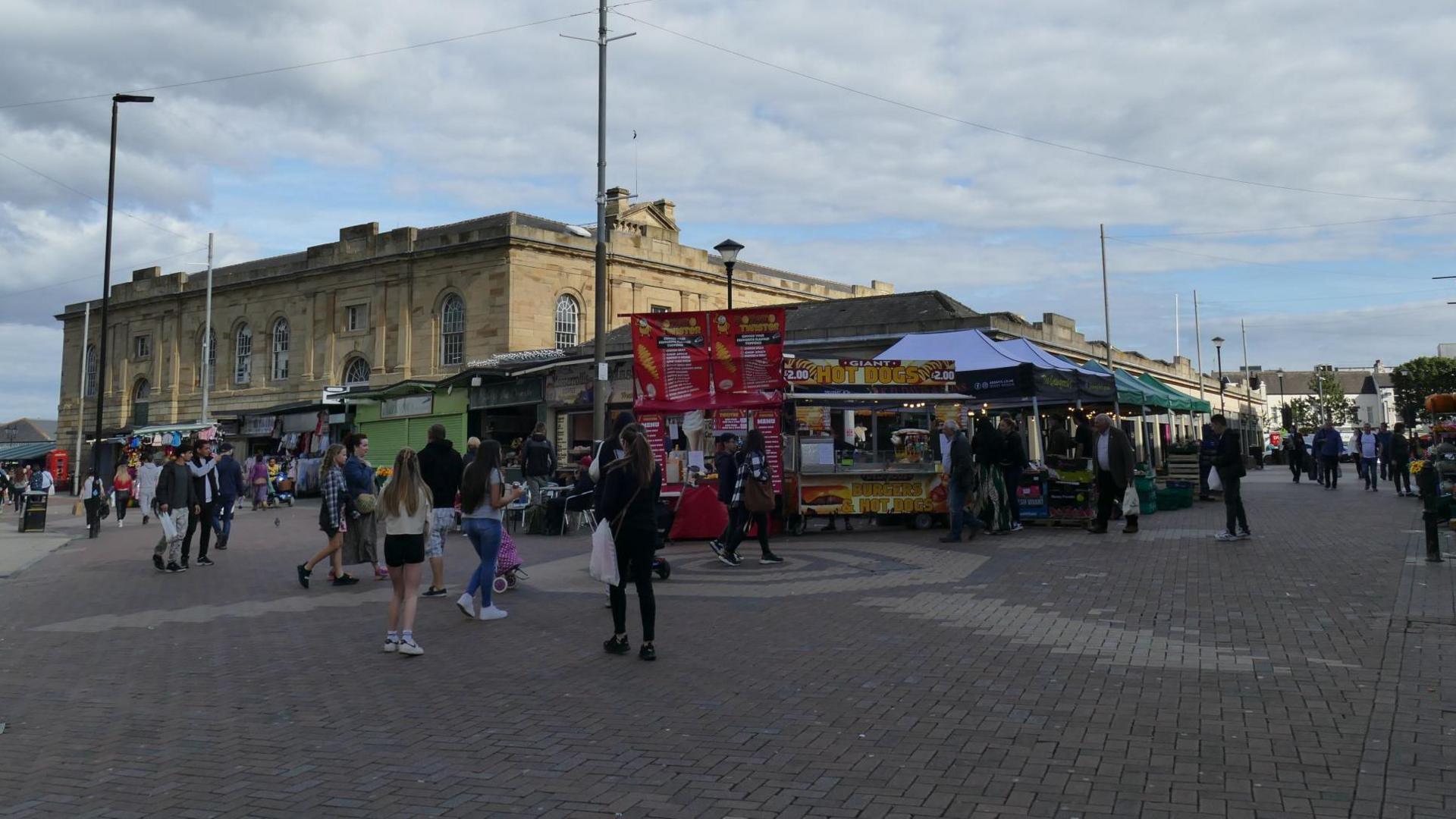 People walking around Doncaster market