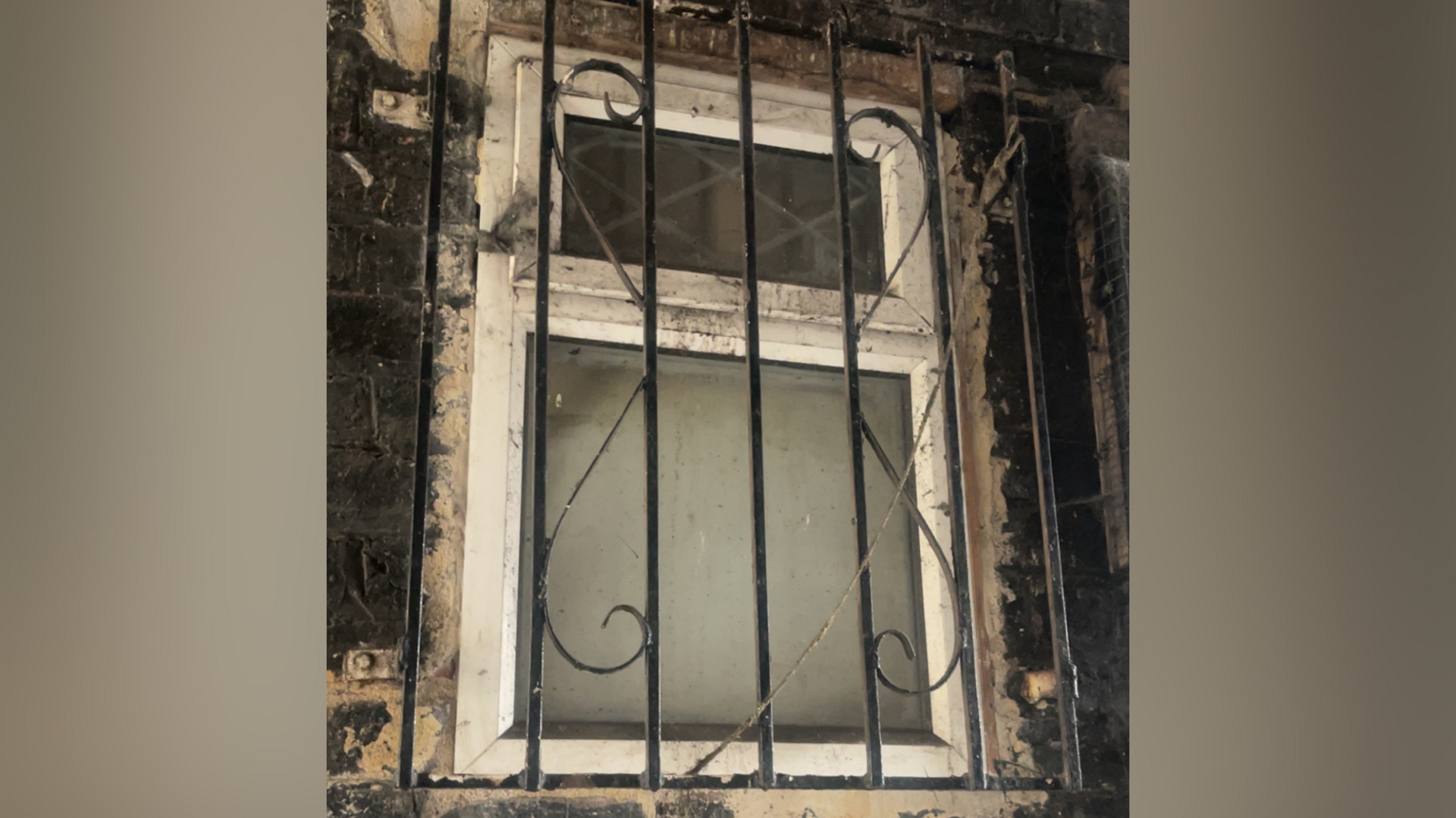 A barred opaque window at one of the locations where the victim was abused