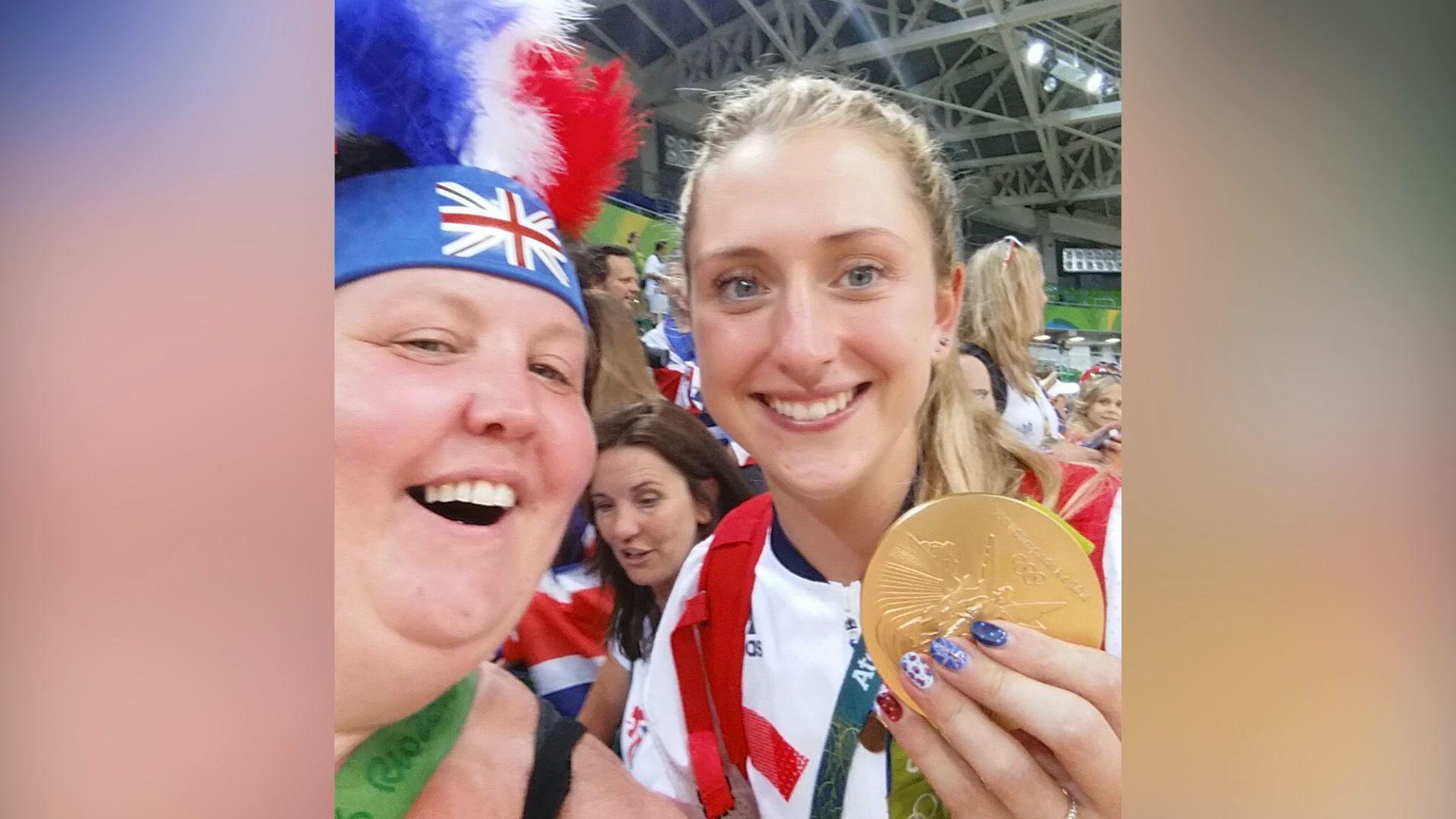 Karolyn Gaston with Team GB Olympian Dame Laura Kenny holding her gold medal in her hand.  Inside the velodrome