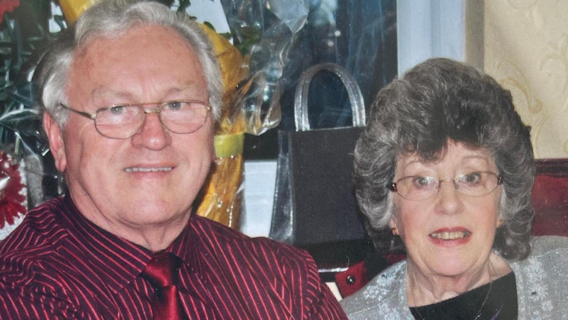 Fred and Elizabeth Owen, sitting down, smiling at the camera