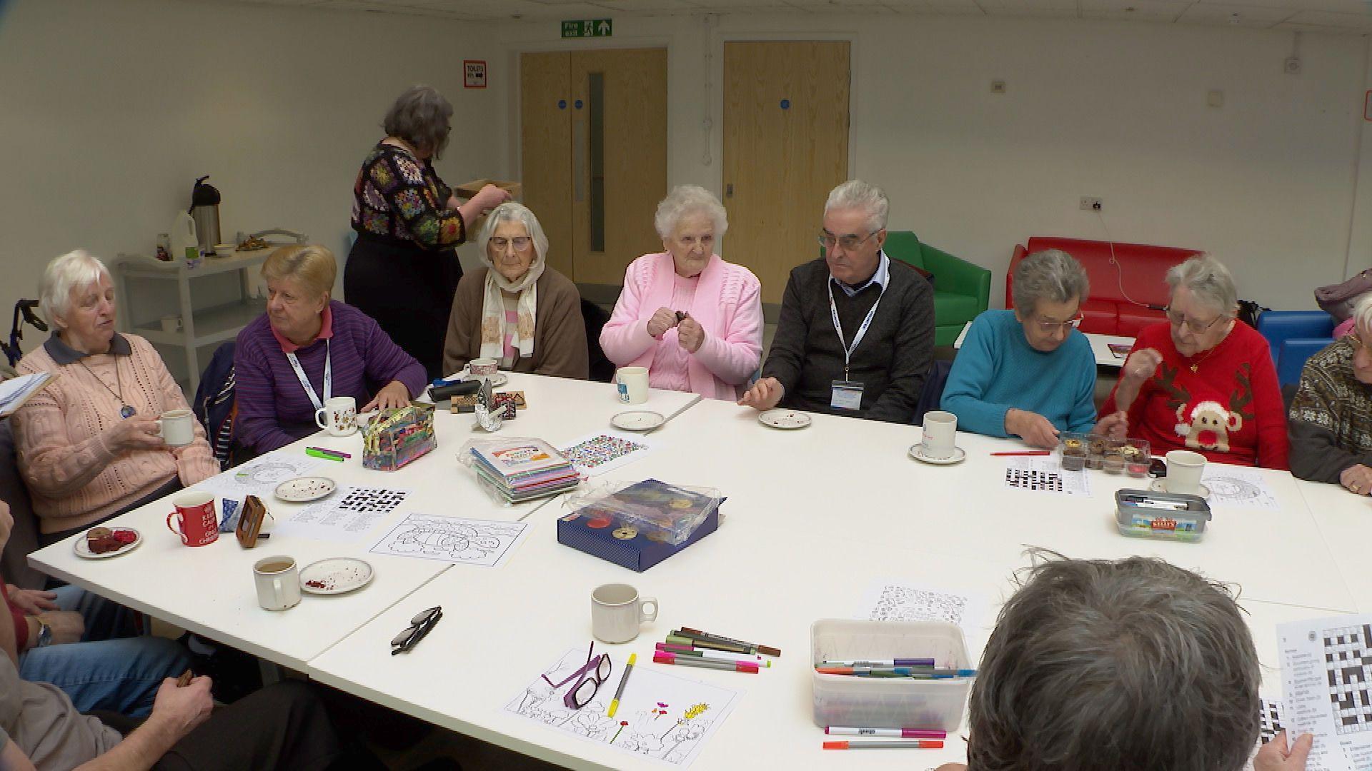 A group of elderly residents around a table