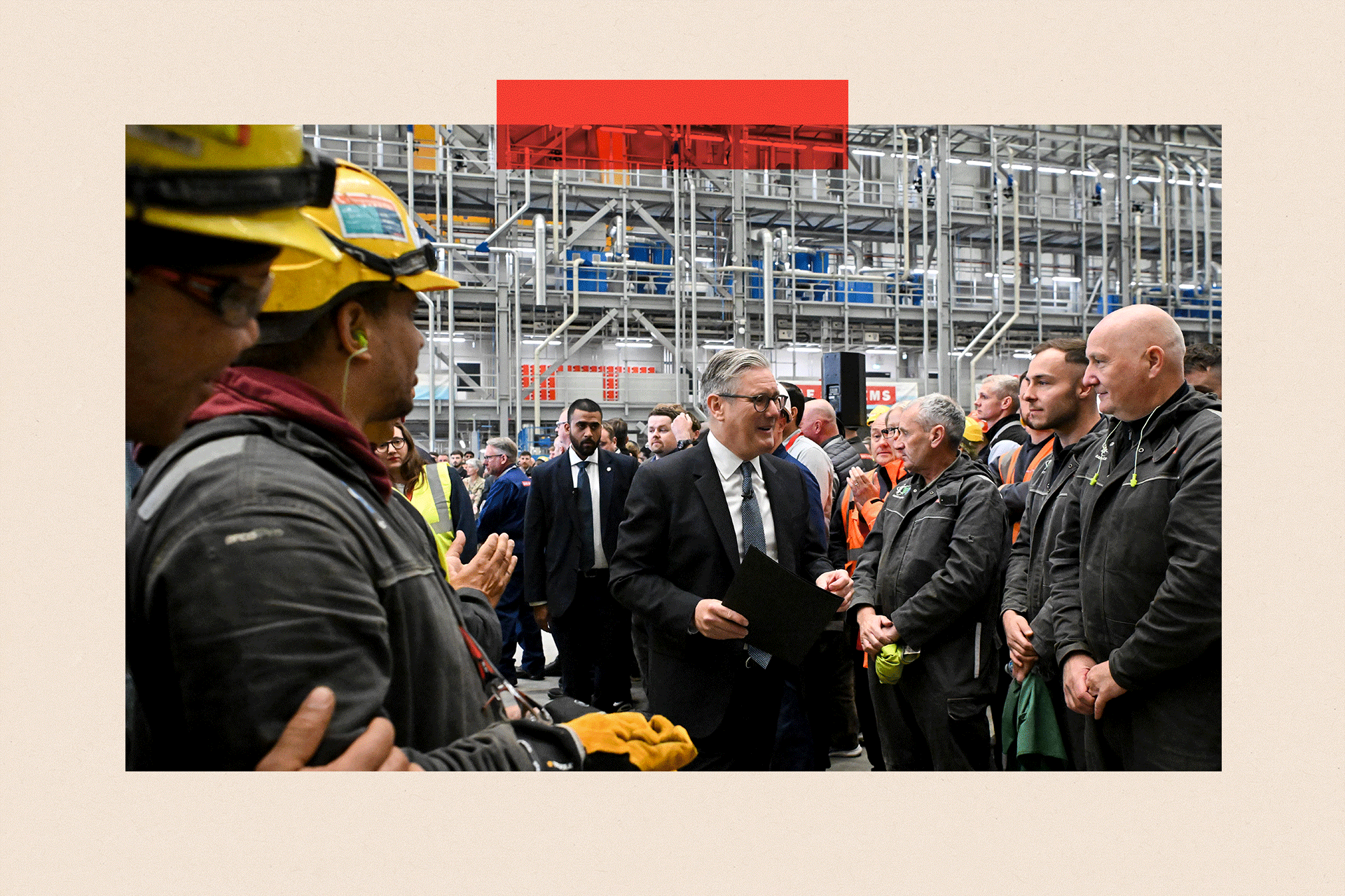 Keir Starmer (C) speaks with members of staff as he leaves the stage after delivering a speech during a visit to the BAE Systems'Govan facility
