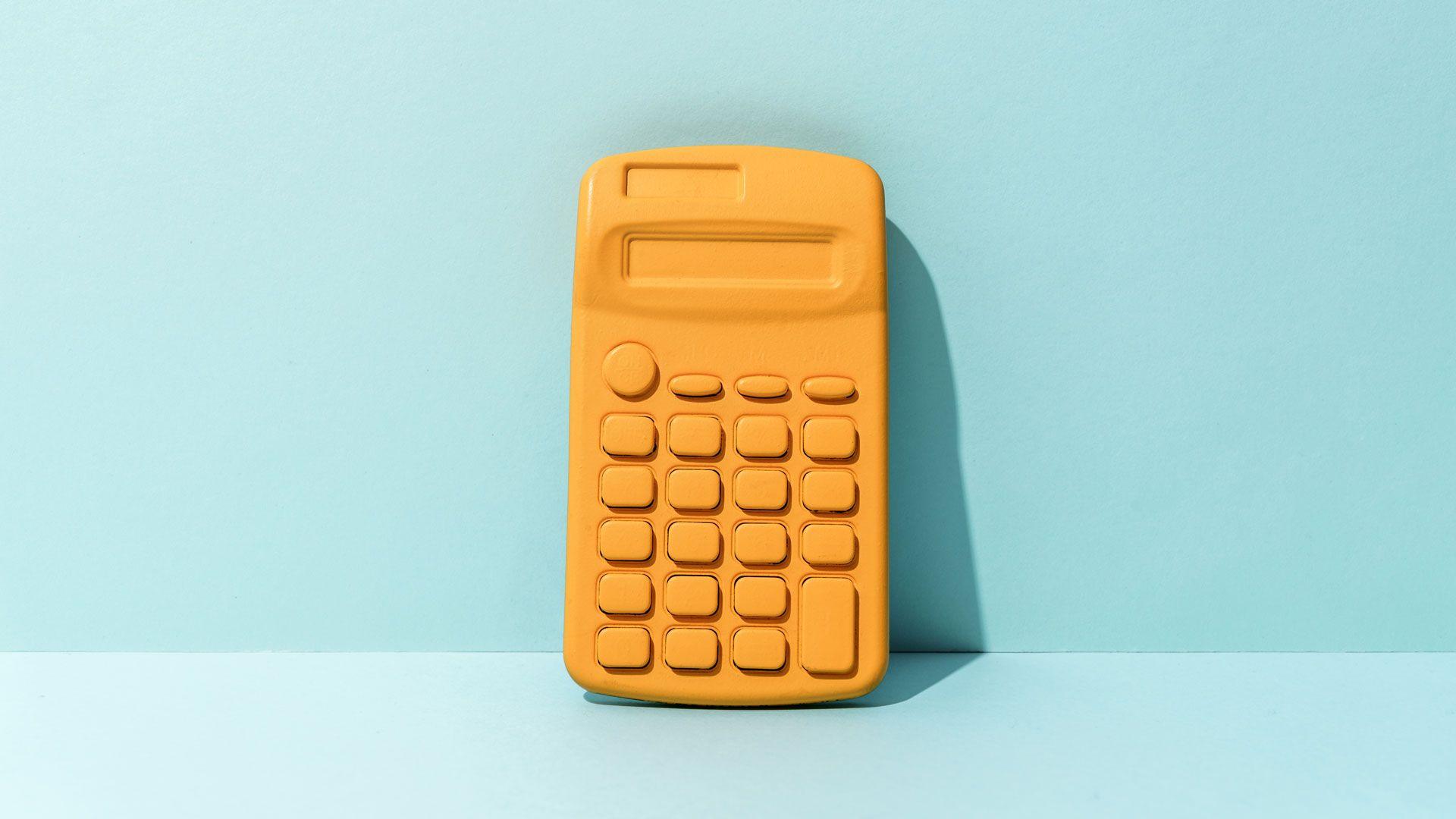 Yellow calculator on light blue background