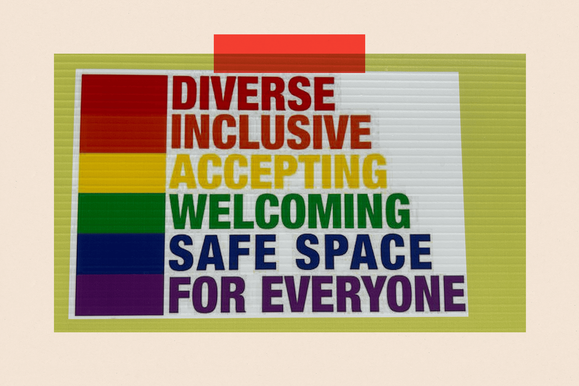 A poster with rainbow colours reads: "Diverse, inclusive, accepting, welcoming, safe space and for everyone"