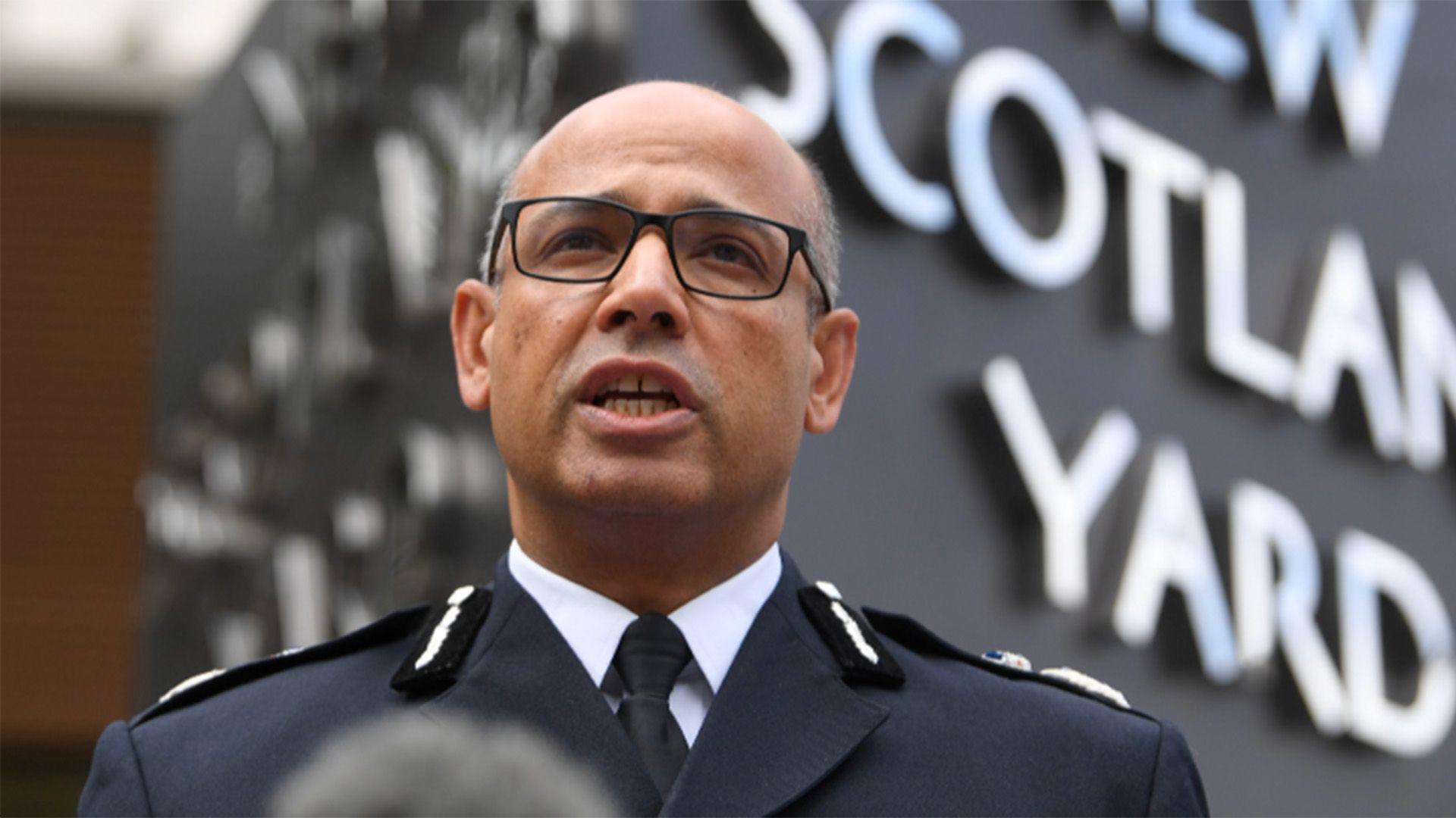 Former Assistant Commissioner Neil Basu speaking into a microphone outside Scotland Yard. 