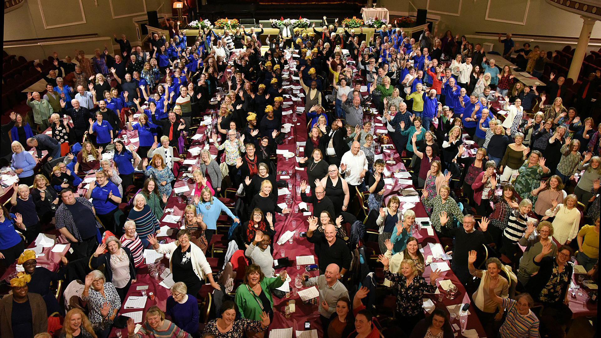 An aerial shot of the Villa Marina, hundreds of people are sitting at long dining tables.