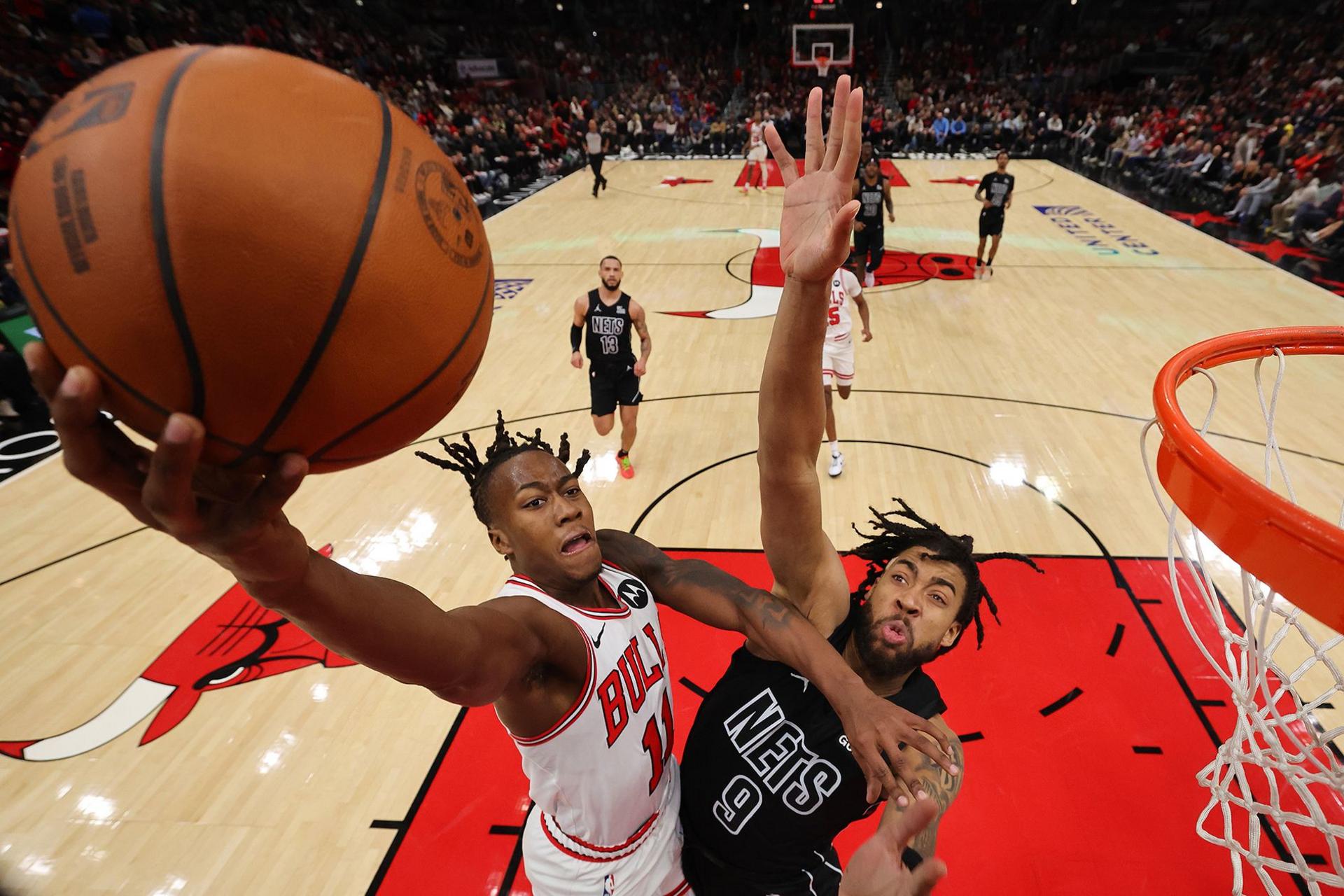 Ayo Dosunmu of the Chicago Bulls goes up for a lay-up against the Brooklyn Nets' Trendon Watford at the United Center in Chicago