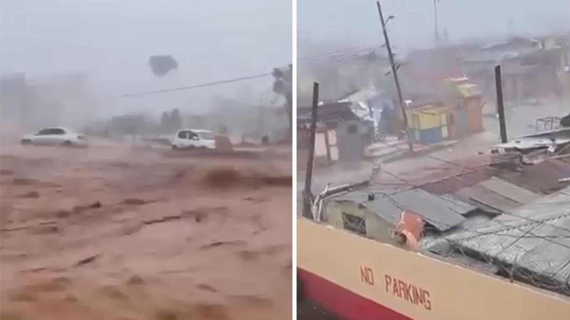 Two blurred images. Left image shows deep brown water pouring through a street during a storm. Two white cars can be seen abandoned on the street. The skies are very grey. Right images shows a deserted street lined by shanty shops. Roofs appear to be damaged and telegraph poles are leaning. The sky is very grey.
