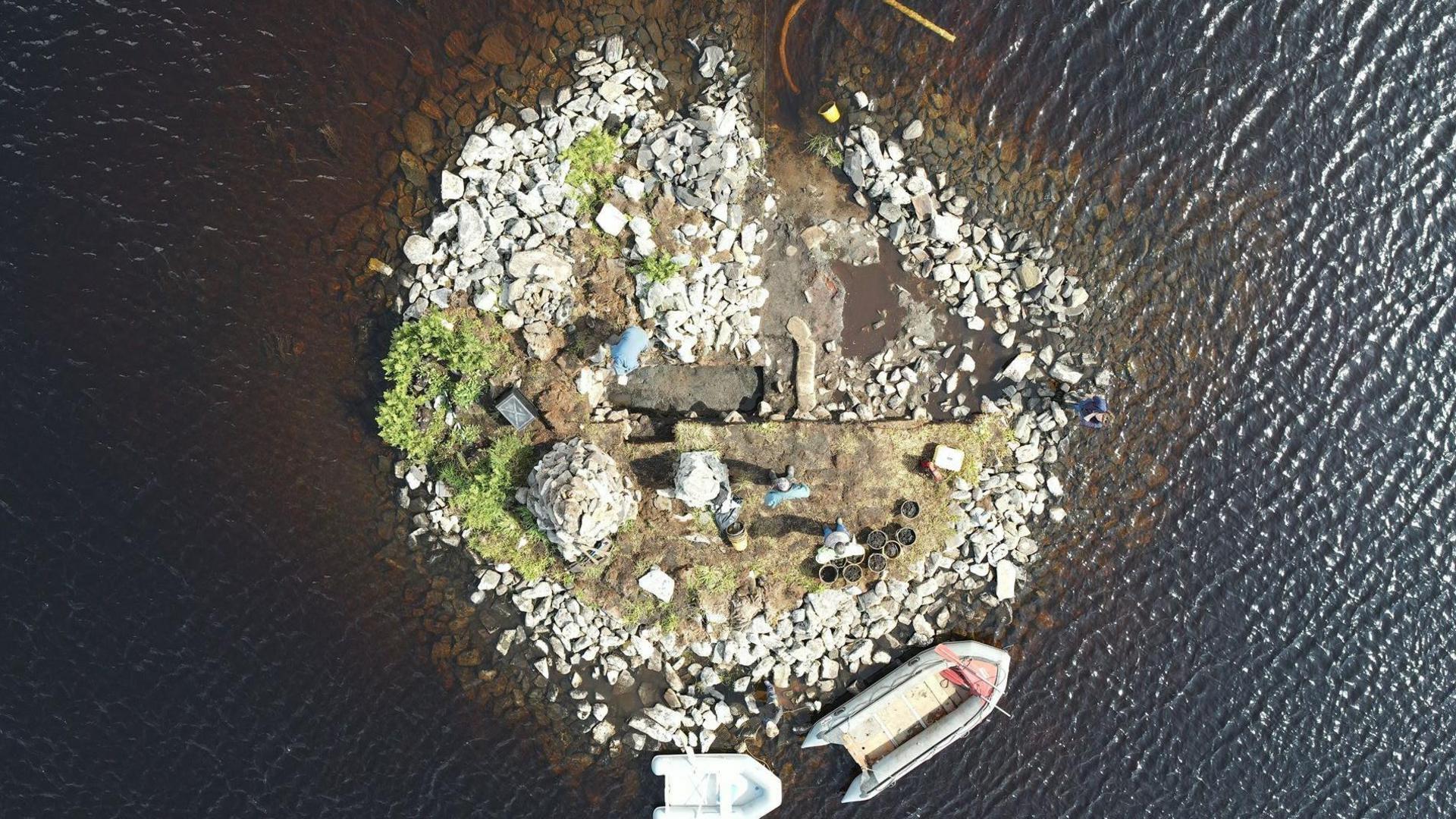 An artificial island built from large white stones in a Scottish loch - captured from above.