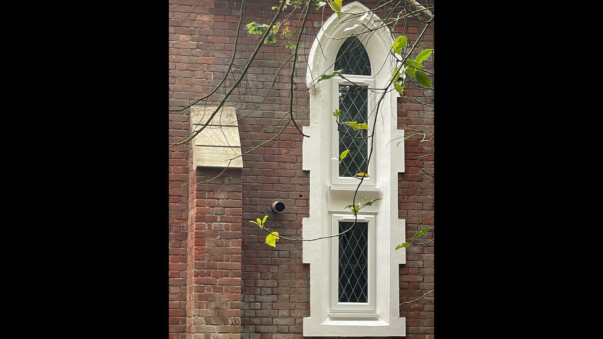 A historic church window is framed with UPVC.