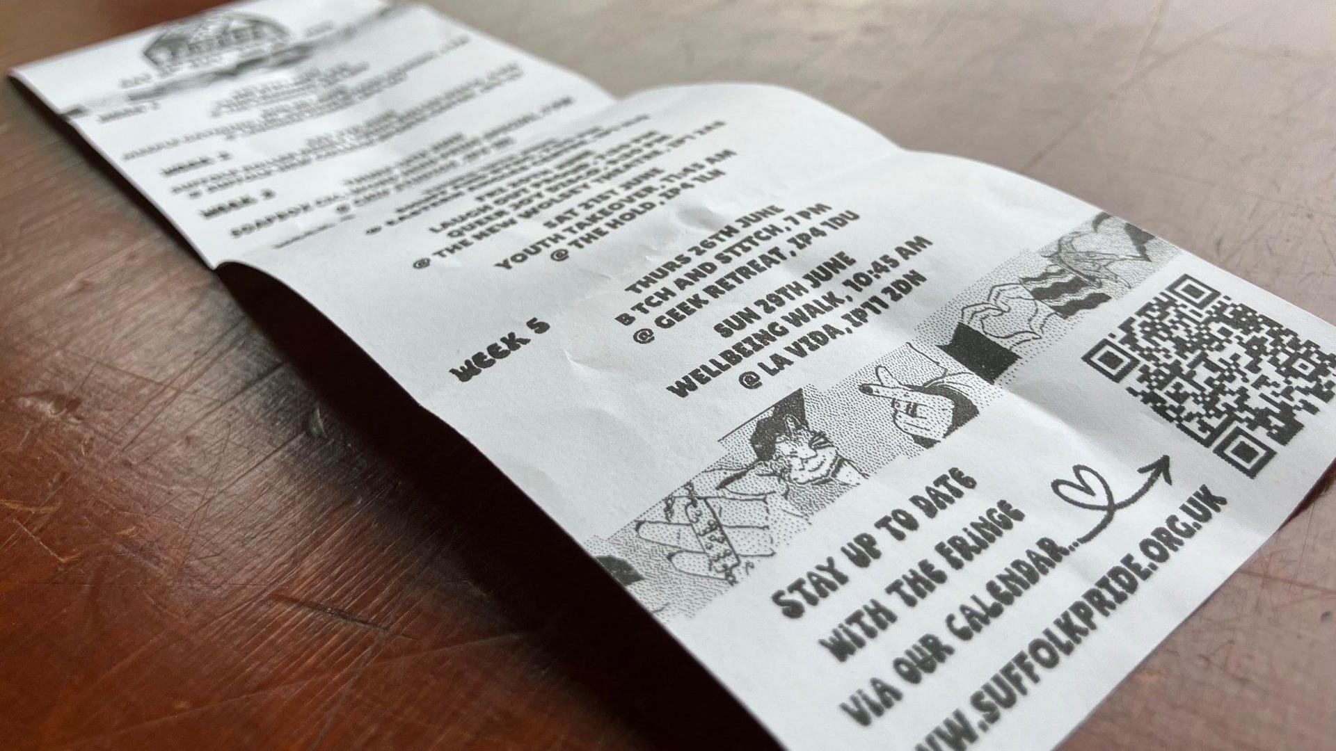 A receipt-style piece of paper with a QR code and readable text which says "Stay up to date with the fringe via our calendar"