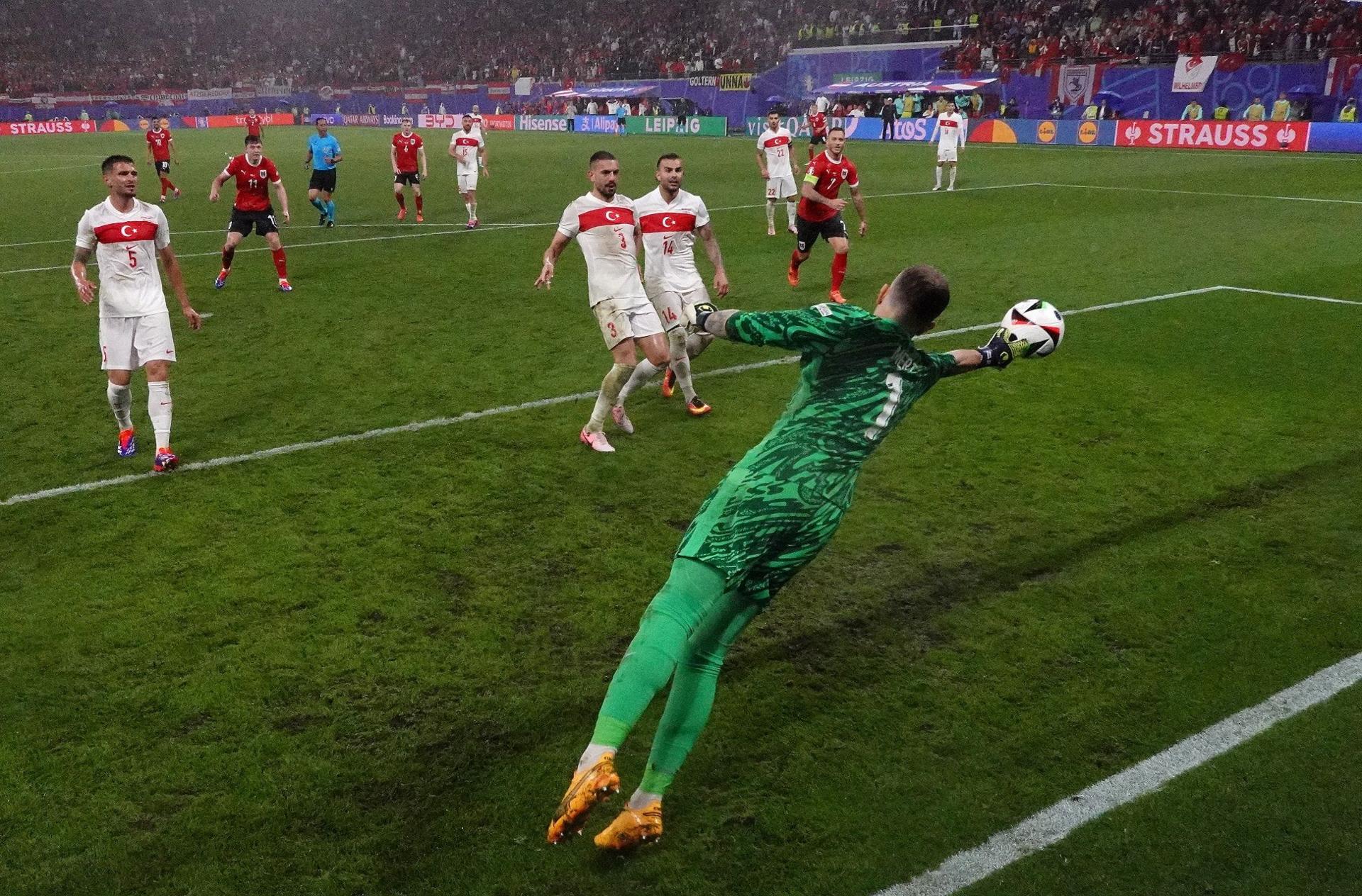 Turkey goalkeeper Mert Gunok saves Christoph Baumgartner's header