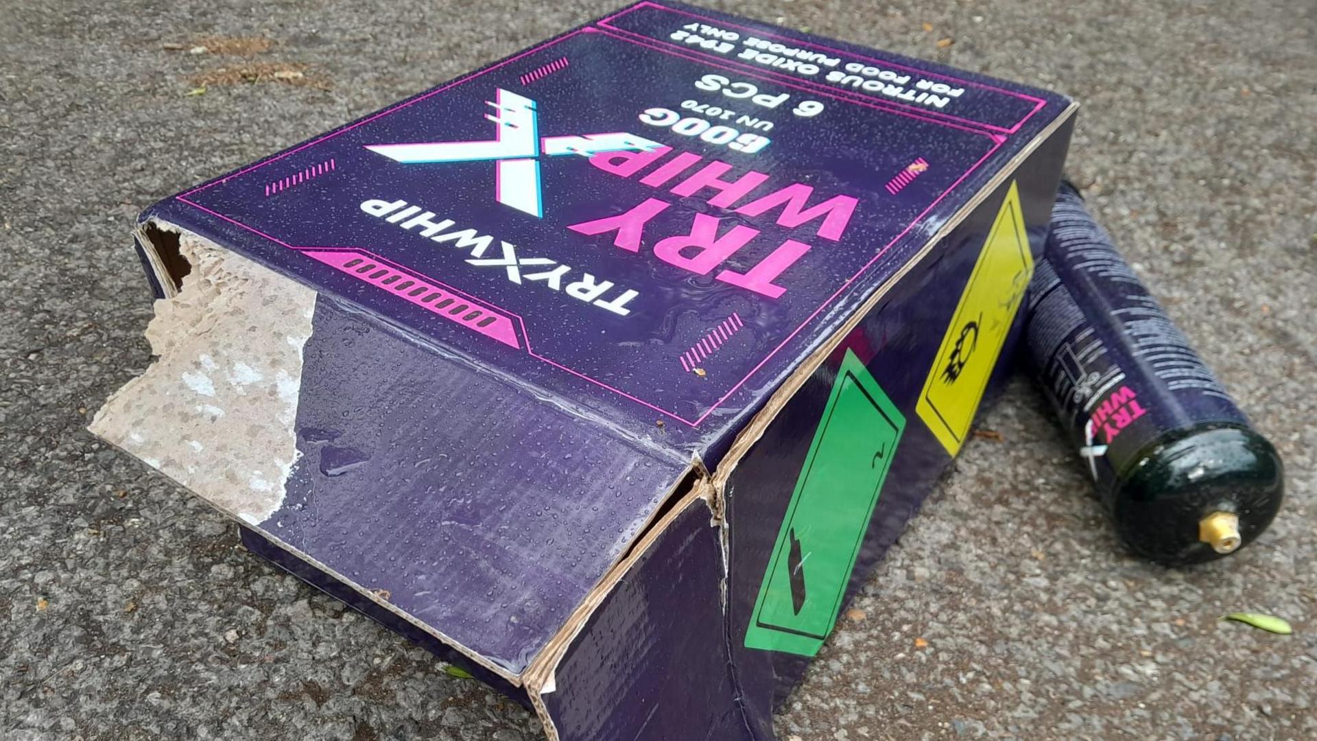 A purple package containing a nitrous oxide cannister.