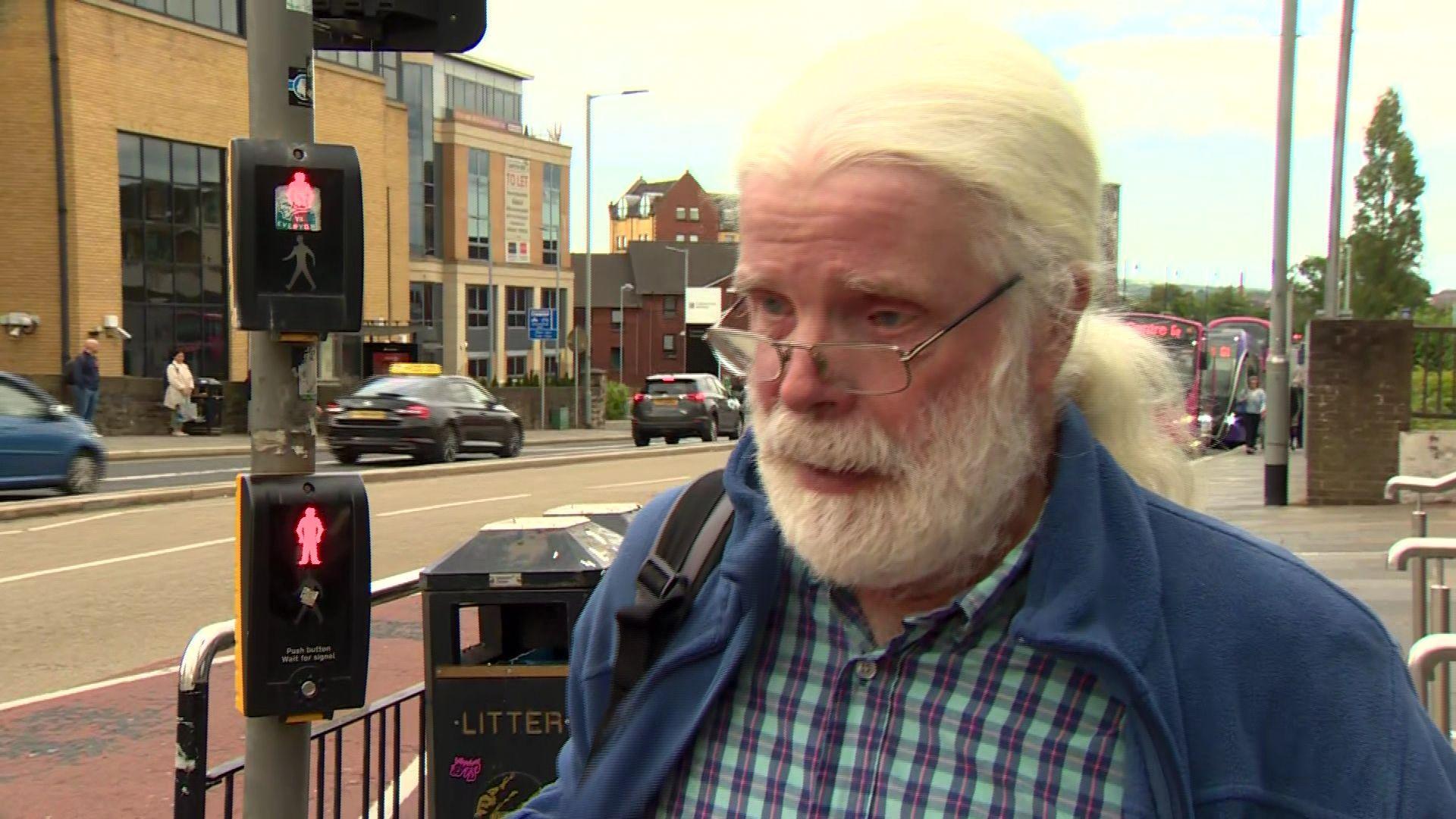 Man with beard outside Lanyon Place rail station